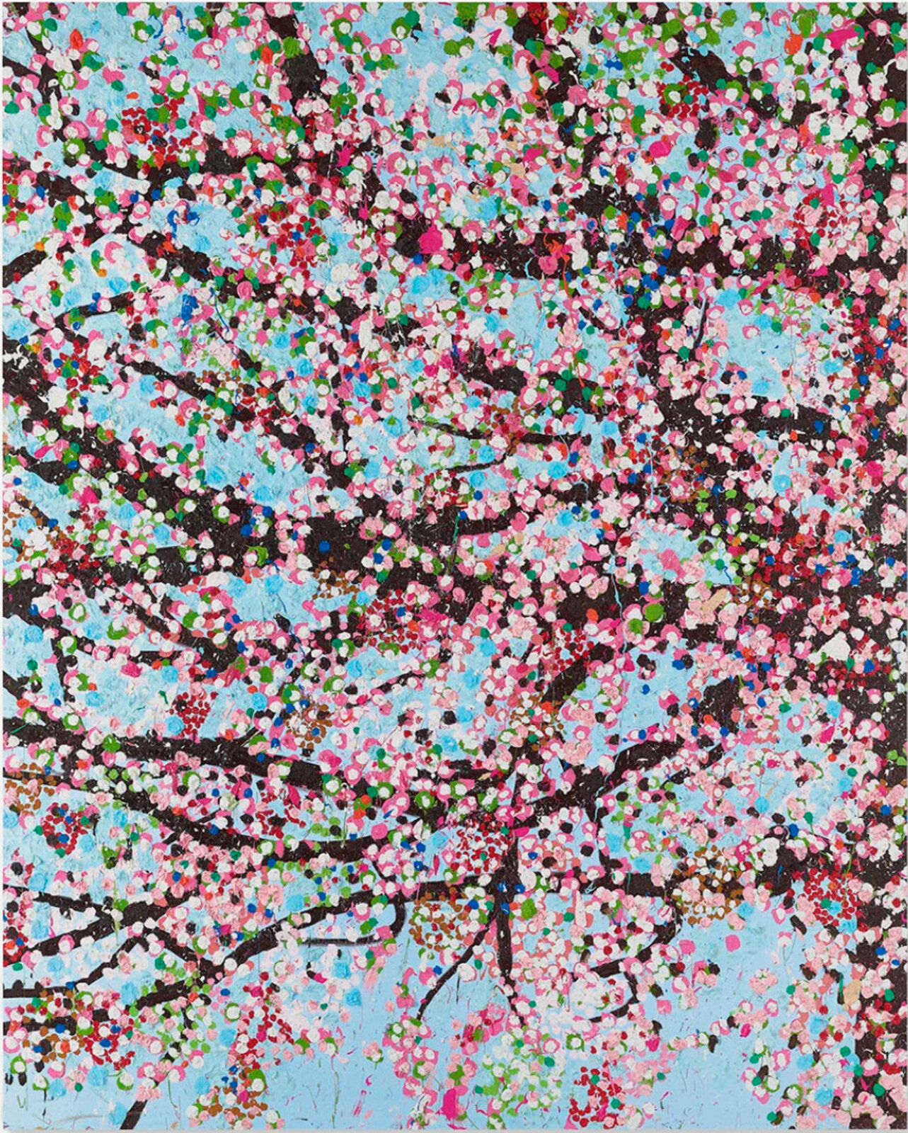 A dense, colorful tree in full bloom against a light blue sky.