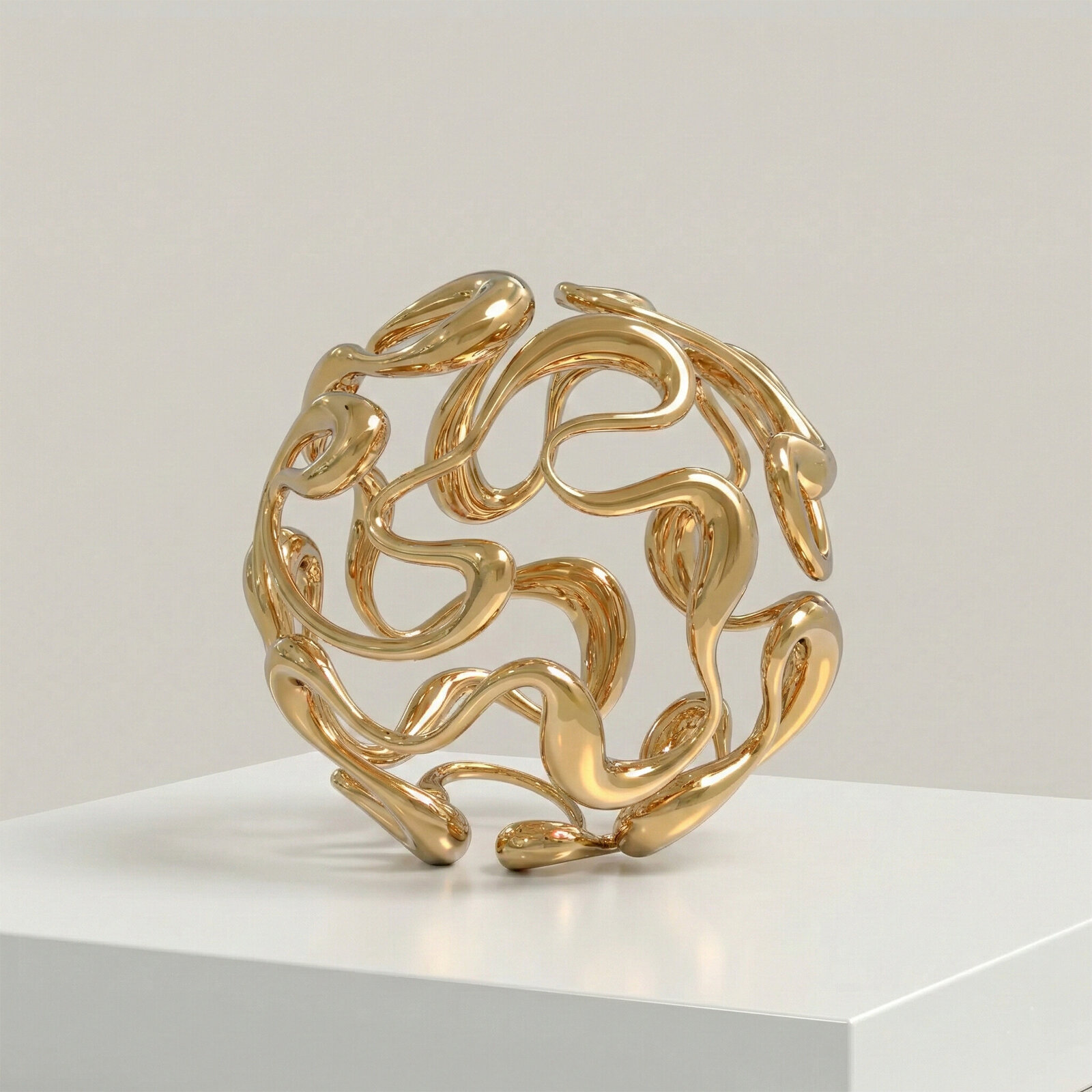 A golden abstract sculpture featuring intertwined, organic forms.