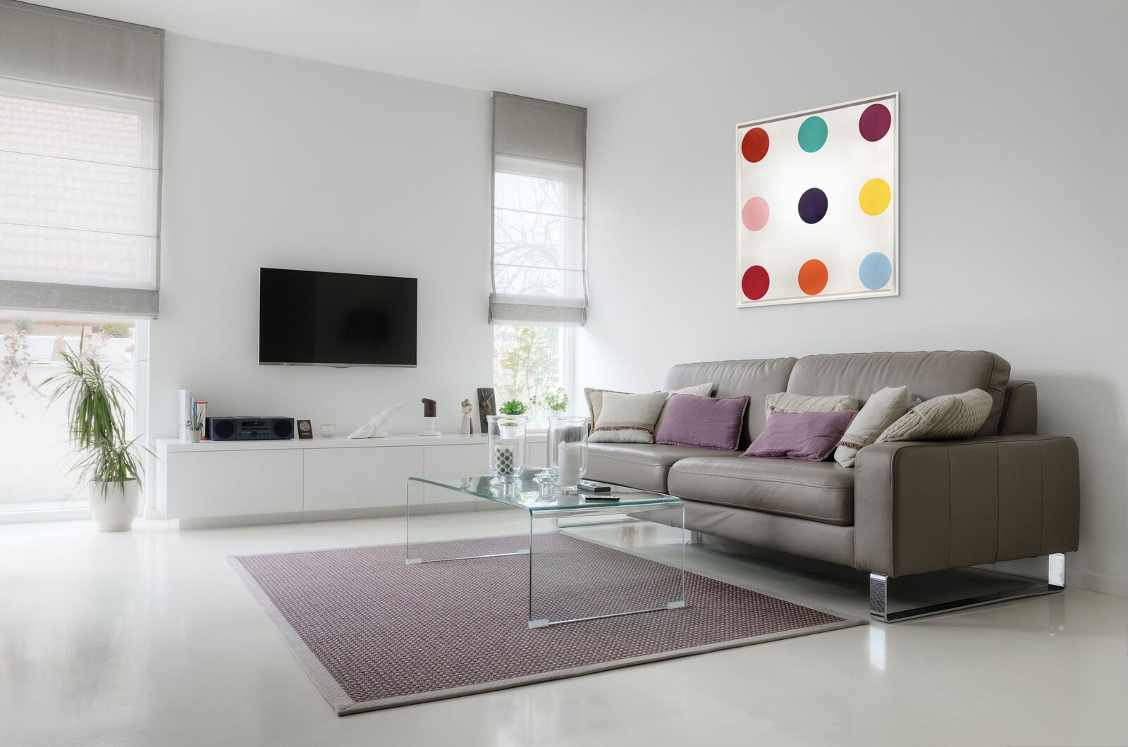 A minimalist composition of nine colored circles arranged in a grid on a white background.