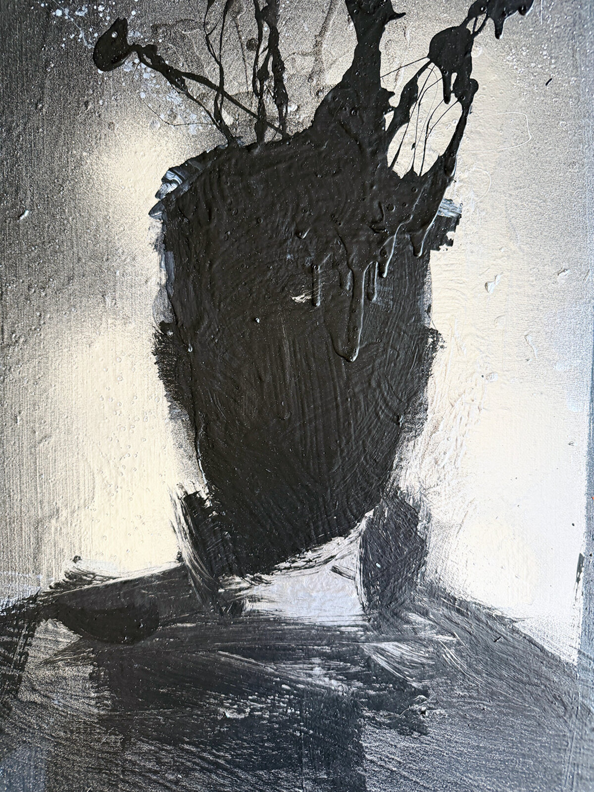 A monochromatic portrait of a figure with an expressive, dripping black head against a textured background.