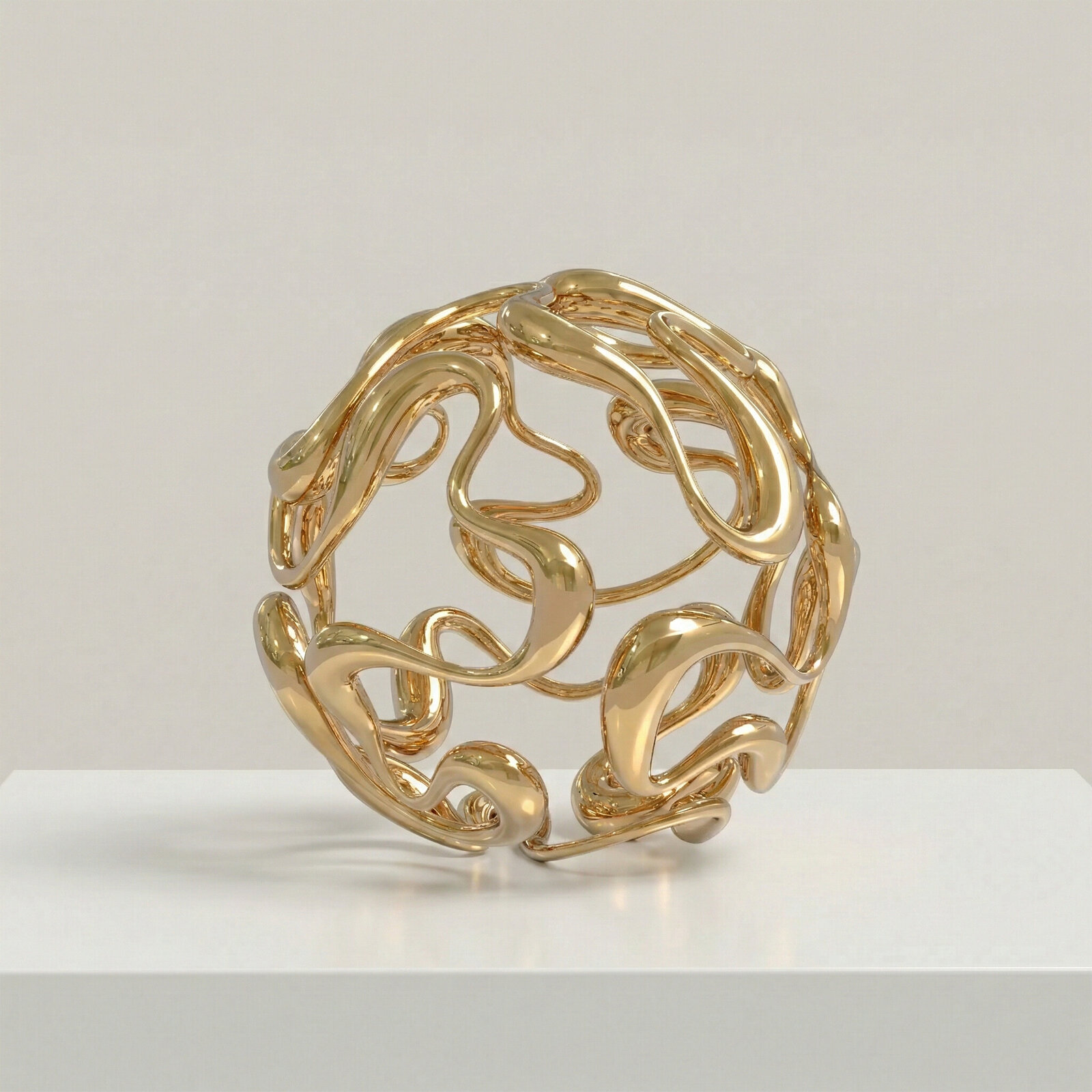 A golden abstract sculpture featuring intertwined, organic forms.