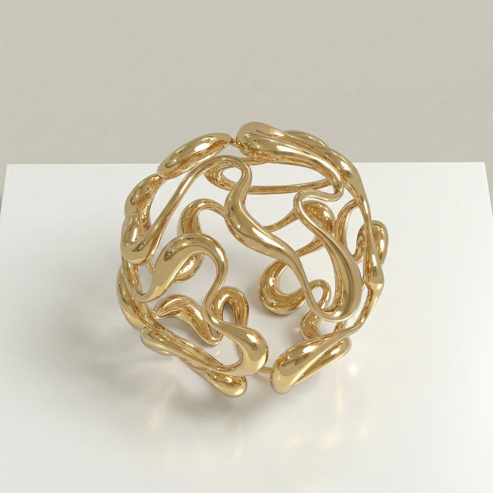 A golden abstract sculpture featuring intertwined, organic forms.