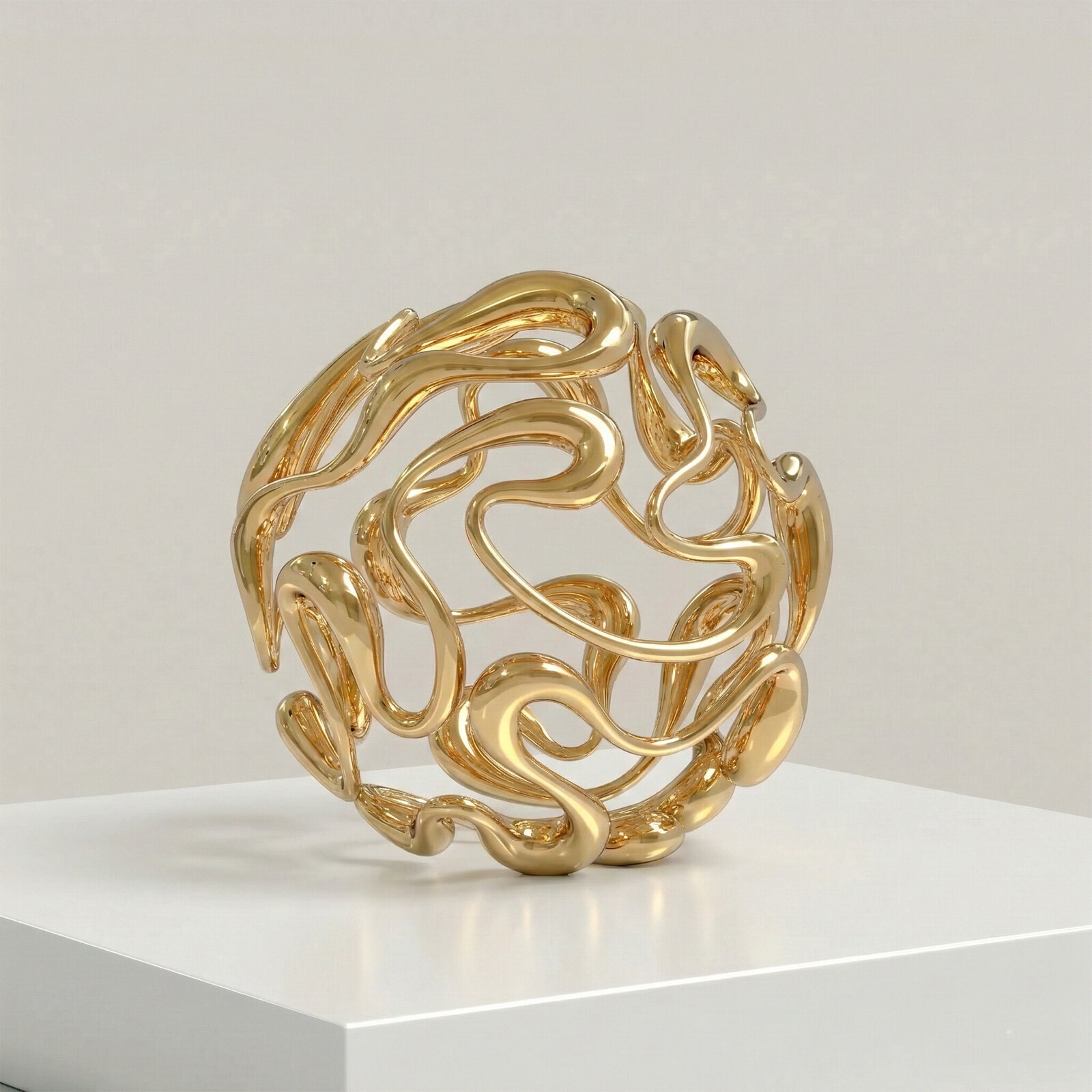 A golden abstract sculpture featuring intertwined, organic forms.