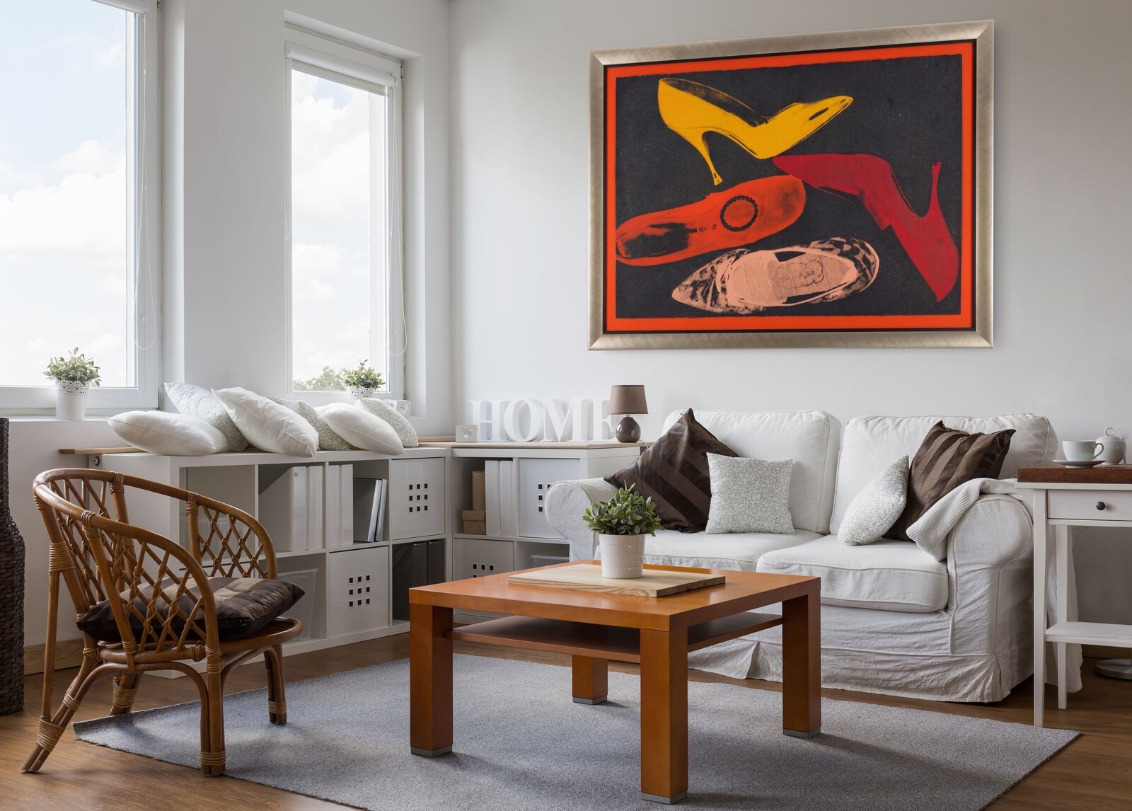A graphic print of four high-heeled shoes in bold colors against a dark background.