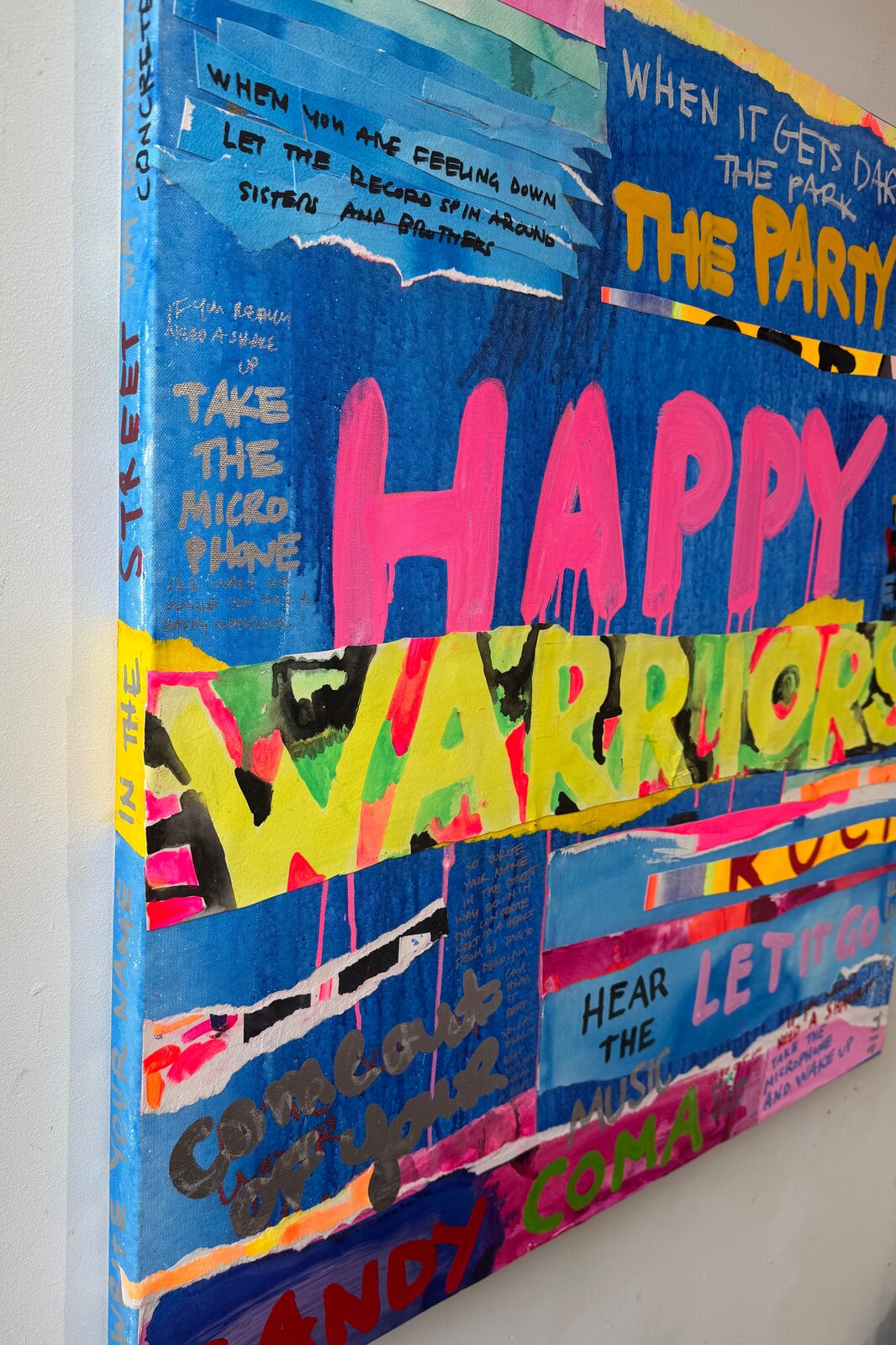 A chaotic, colorful collage of text and paint splatters on a blue background.