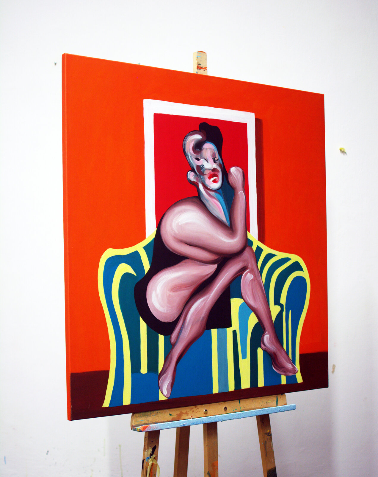 A modern living room scene featuring a bold pop-art painting on the wall above a sectional sofa.