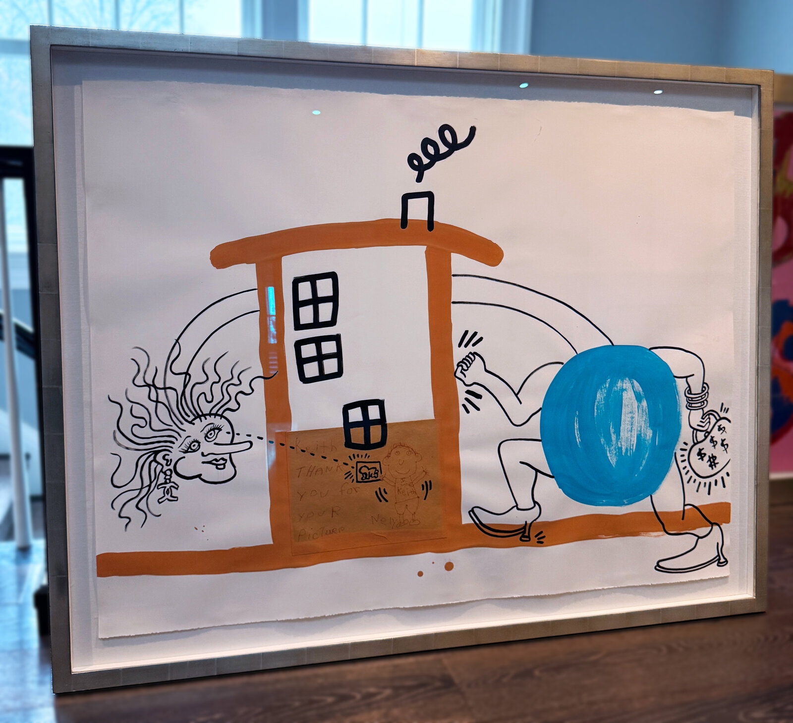 A whimsical mixed-media collage featuring a cartoon figure, a house, and a surreal face.