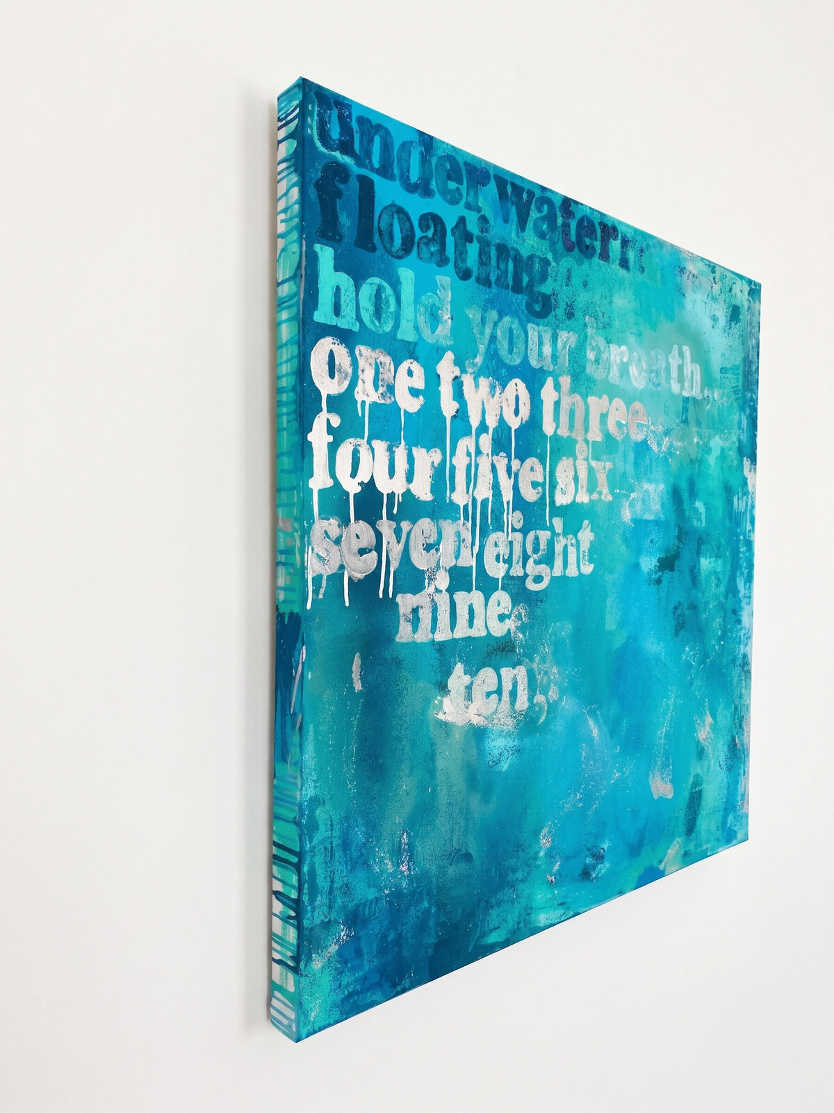 A textured blue and teal artwork featuring white text that reads 'underwater floating hold your breath' over a watercolor-style background.