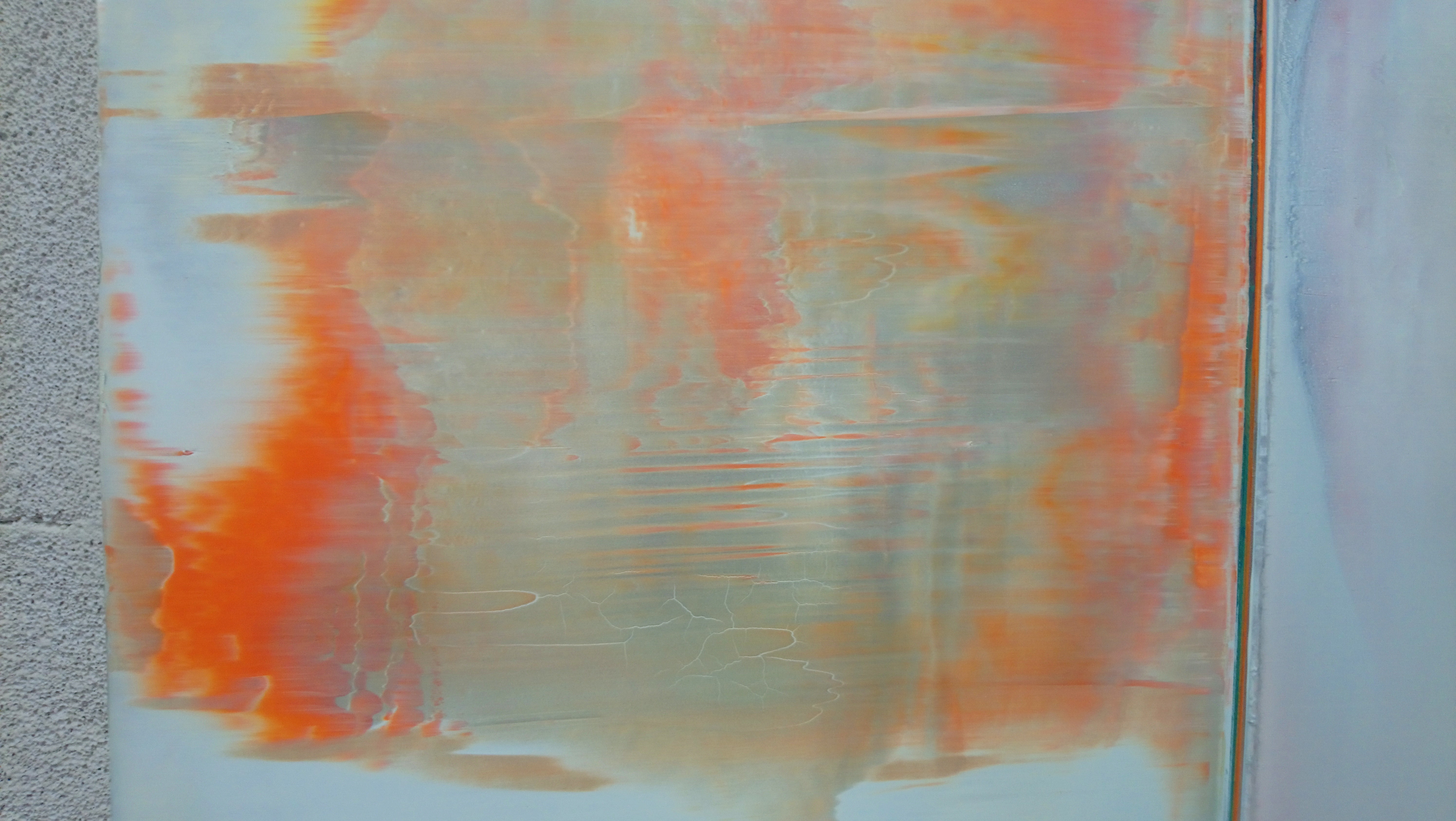 A painting with orange and white paint on a white background.
