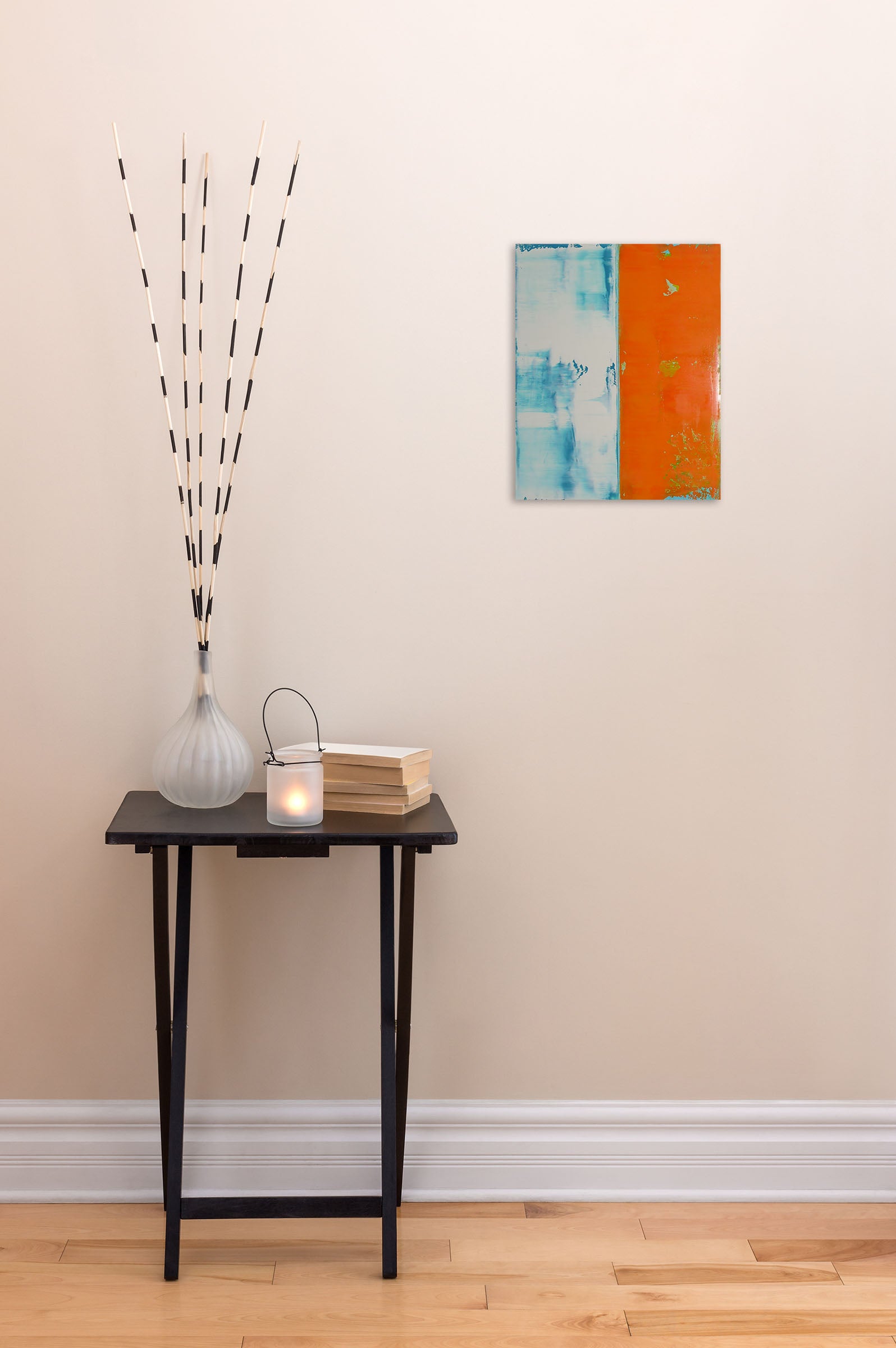 A painting of an orange and blue painting on a white wall.