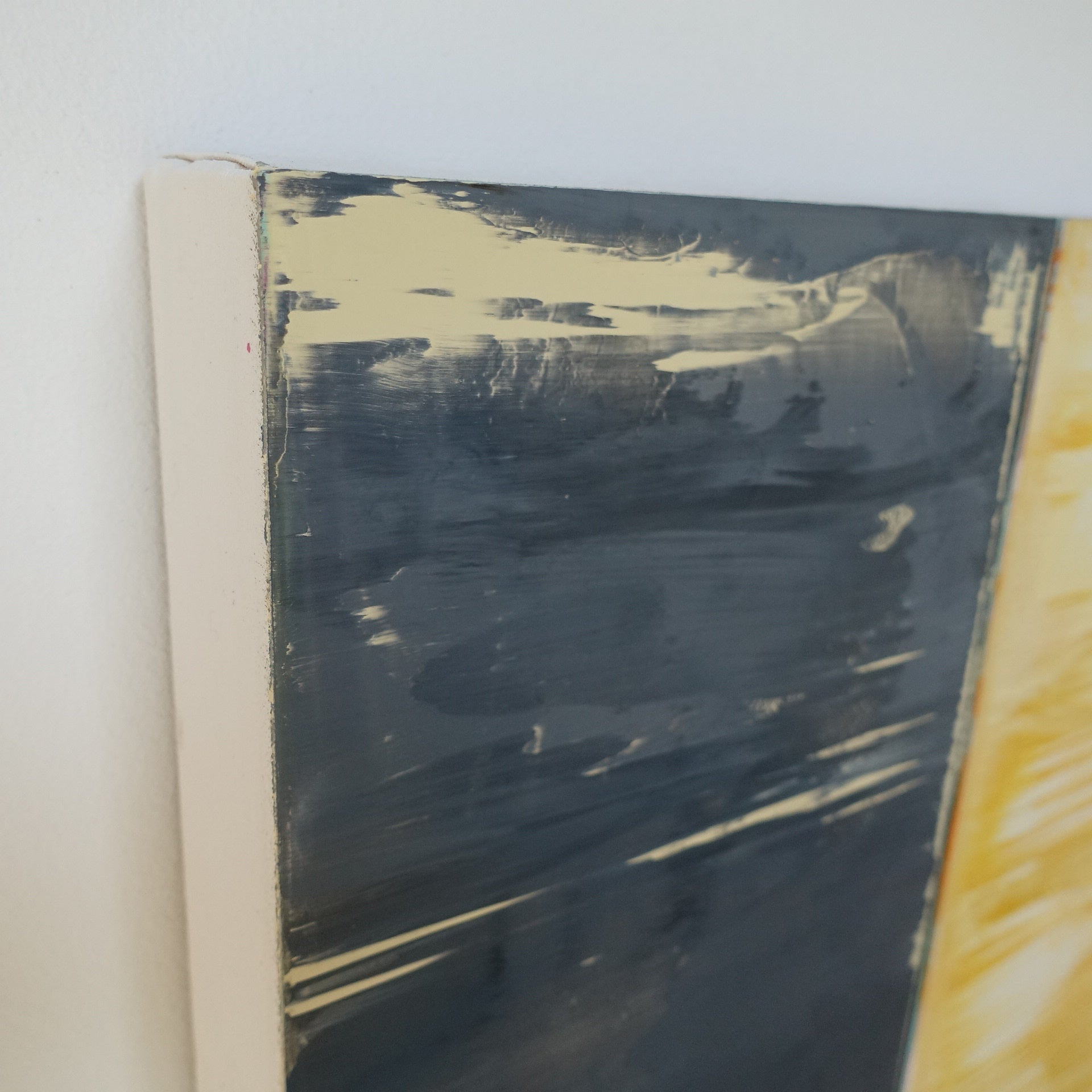 A painting of a yellow and blue painting on a white wall.