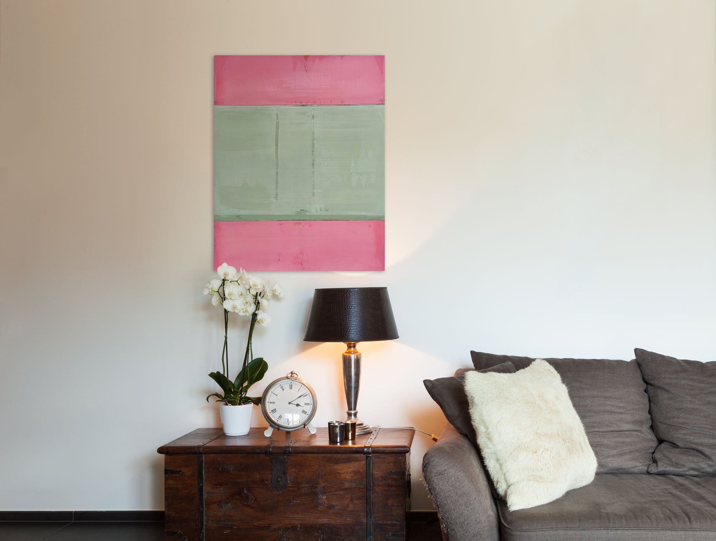A pink and green painting on a white wall.