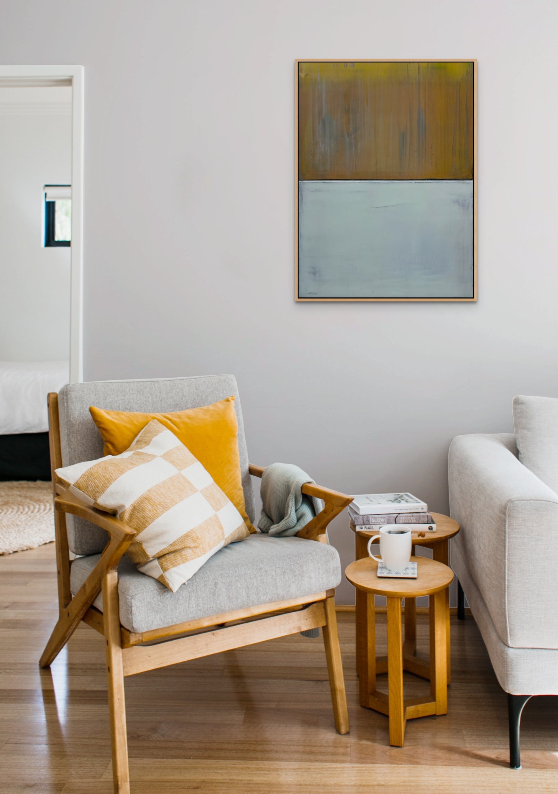 A painting of a yellow and gray painting on a white wall.