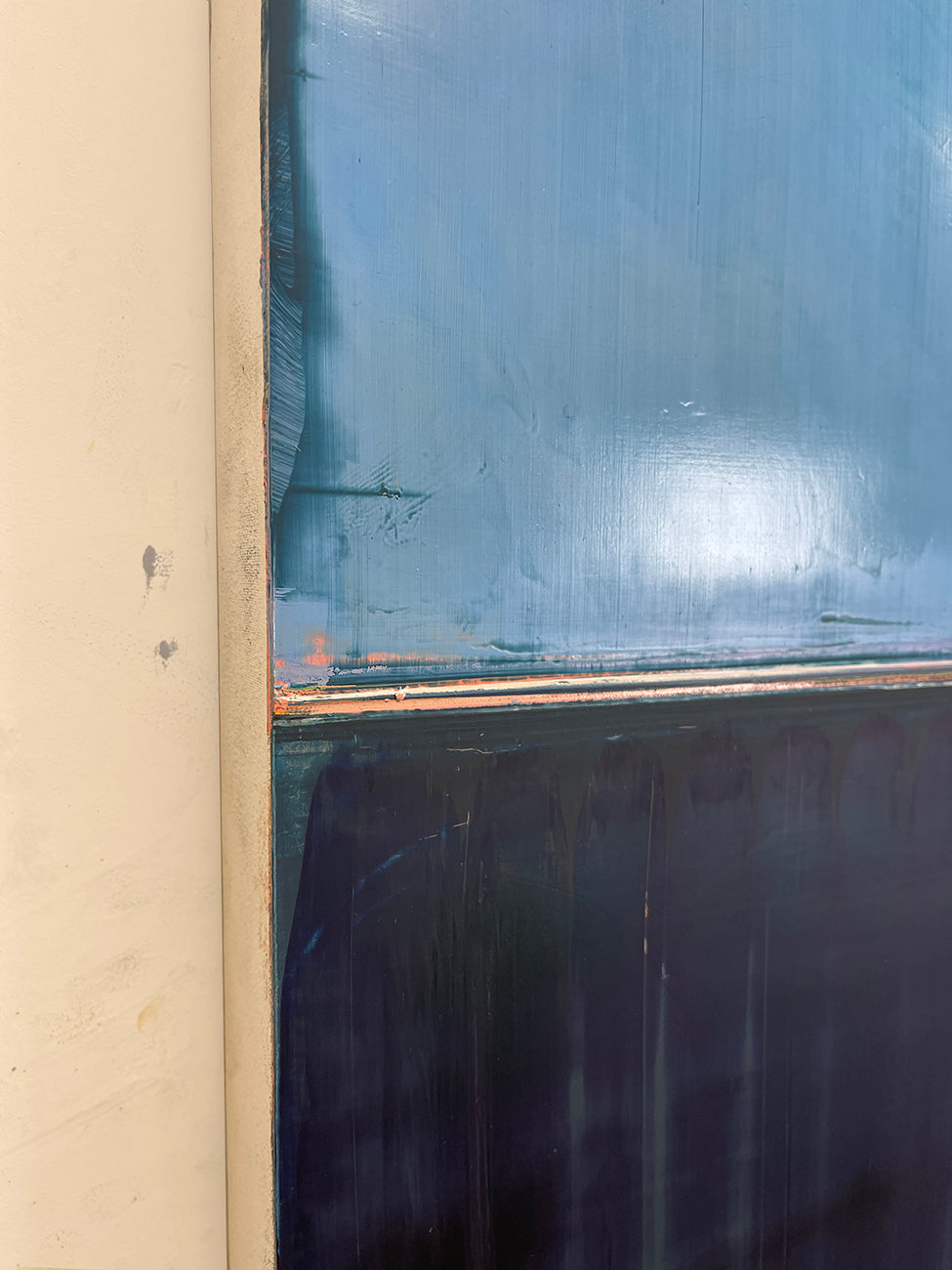 A painting of a blue and black painting on a white wall.