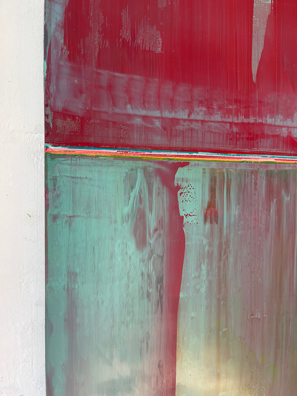 A painting with red and green paint on it. 