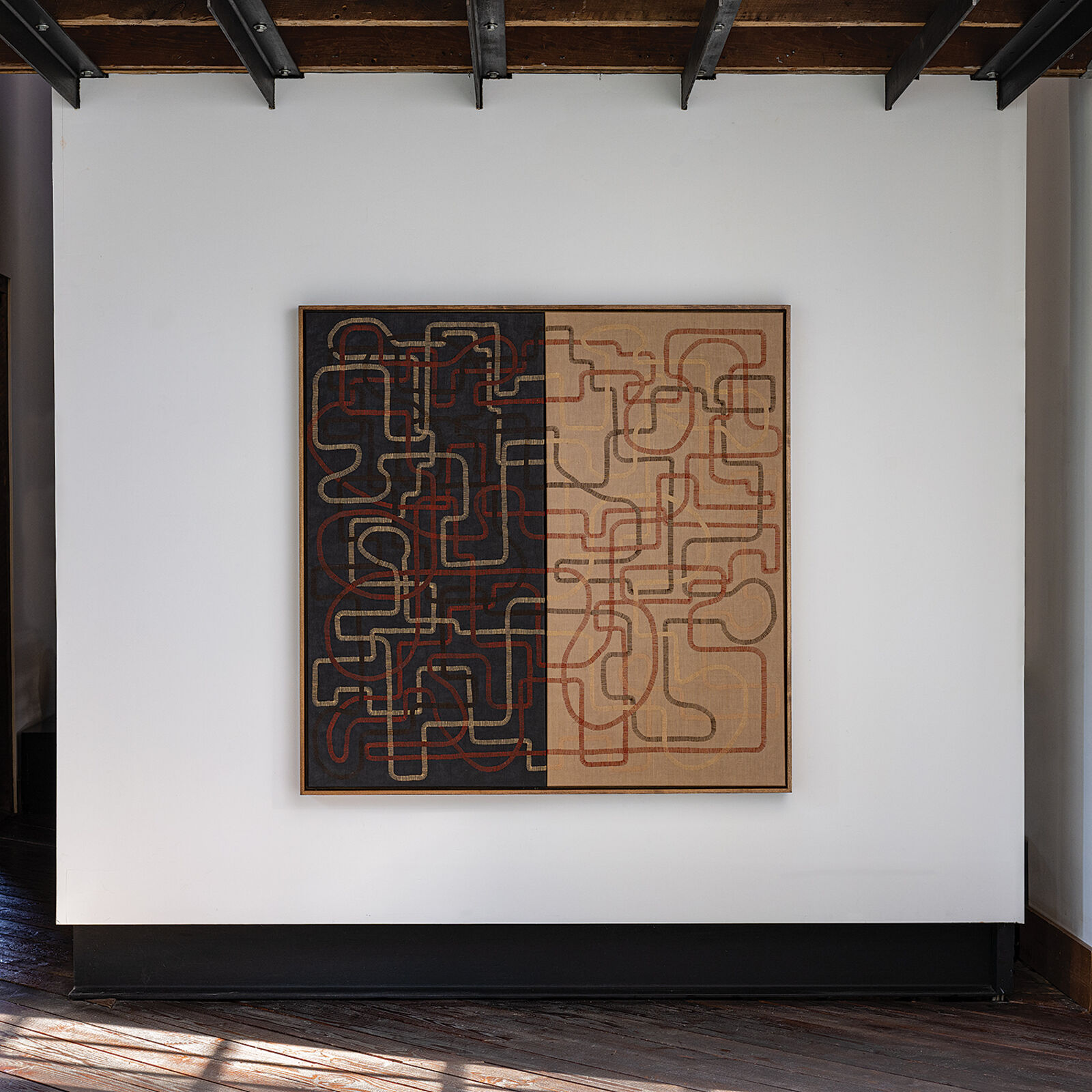 A painting hanging on a wall in a room.