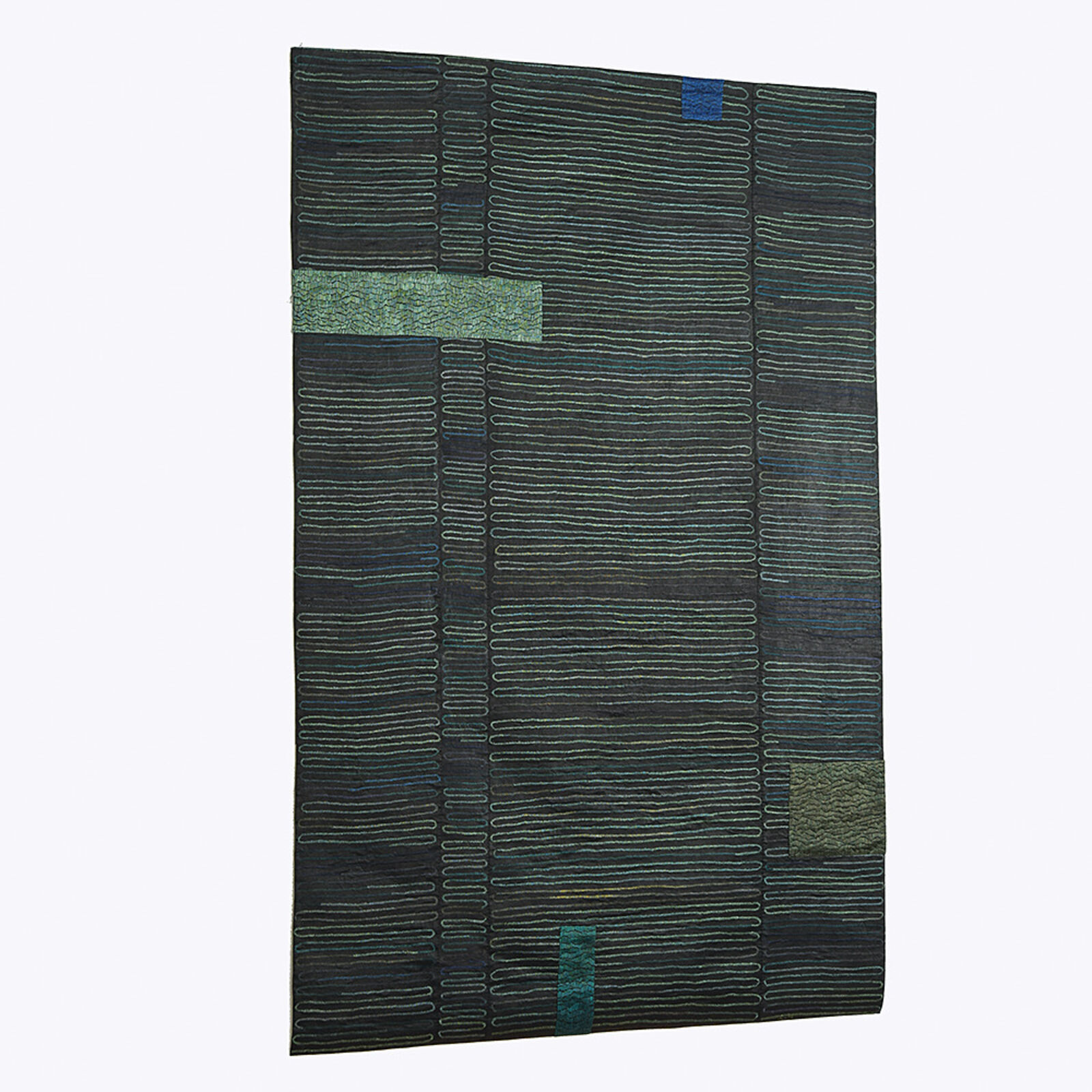 A dark textile featuring a grid of wavy lines and scattered rectangular patches in muted greens and blues.