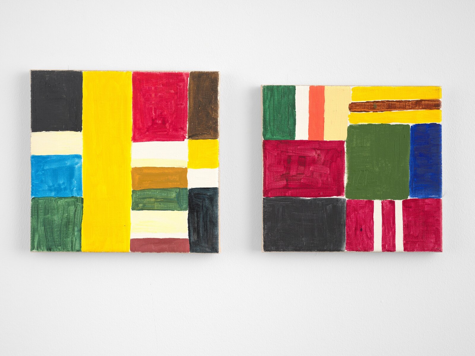 Two small canvases display a vibrant, abstract composition of geometric shapes and bold primary colors.
