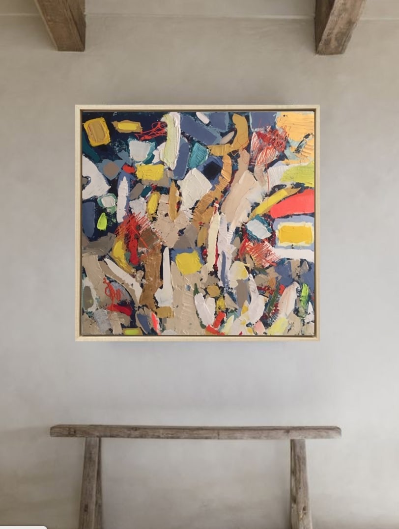 A painting in a gold frame on a white wall.