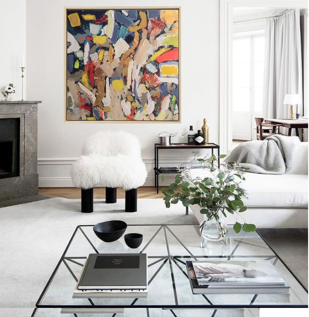 A painting in a gold frame on a white wall.