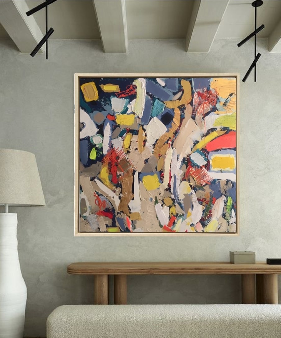 A painting in a gold frame on a white wall.