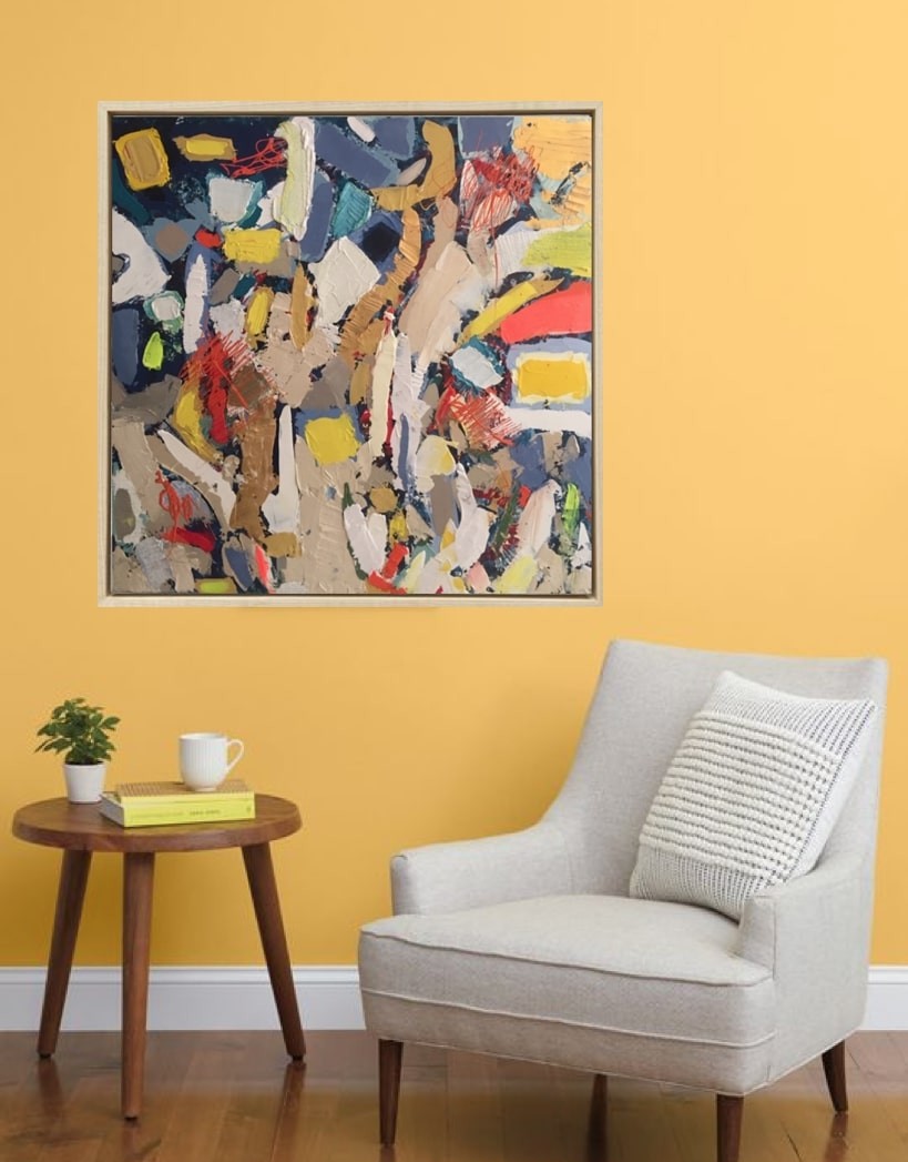 A painting in a gold frame on a white wall.