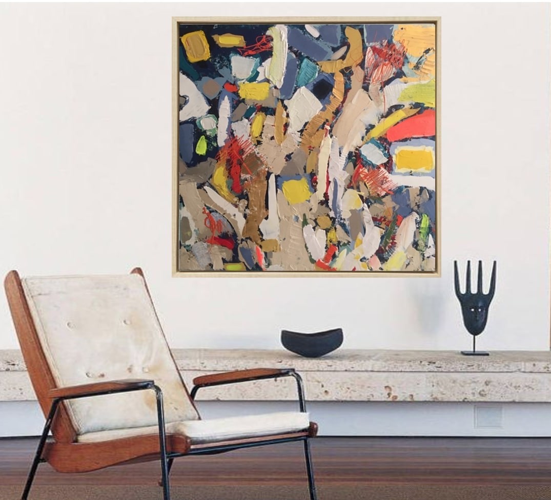 A painting in a gold frame on a white wall.
