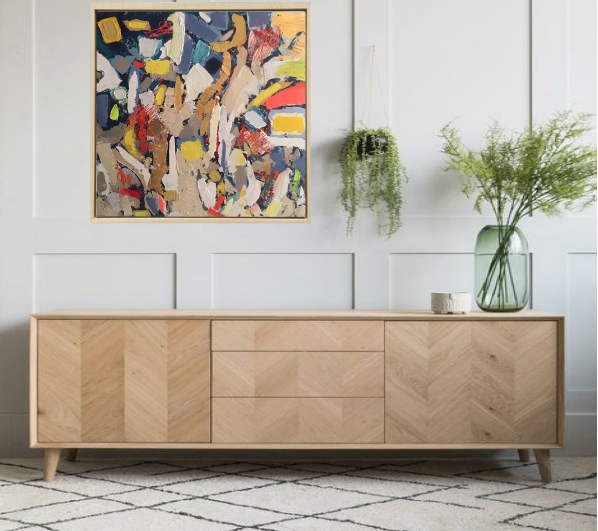 A painting in a gold frame on a white wall.