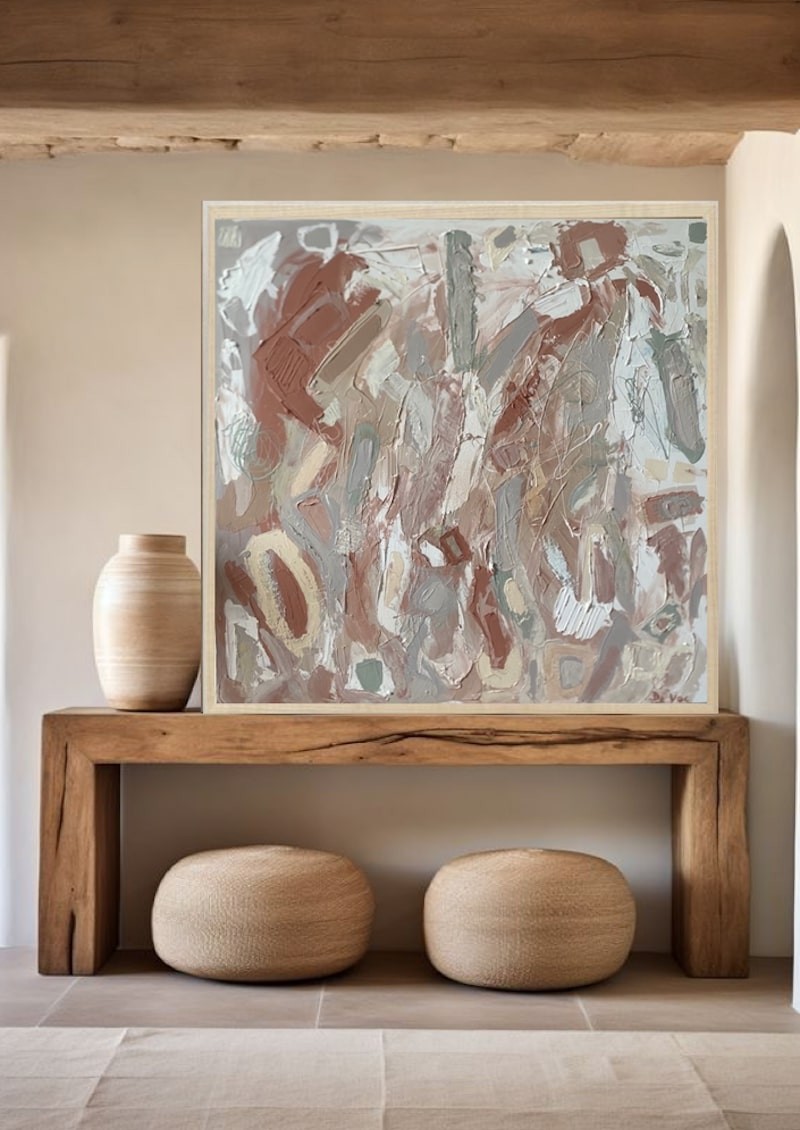 A painting with a wooden frame on a white wall.