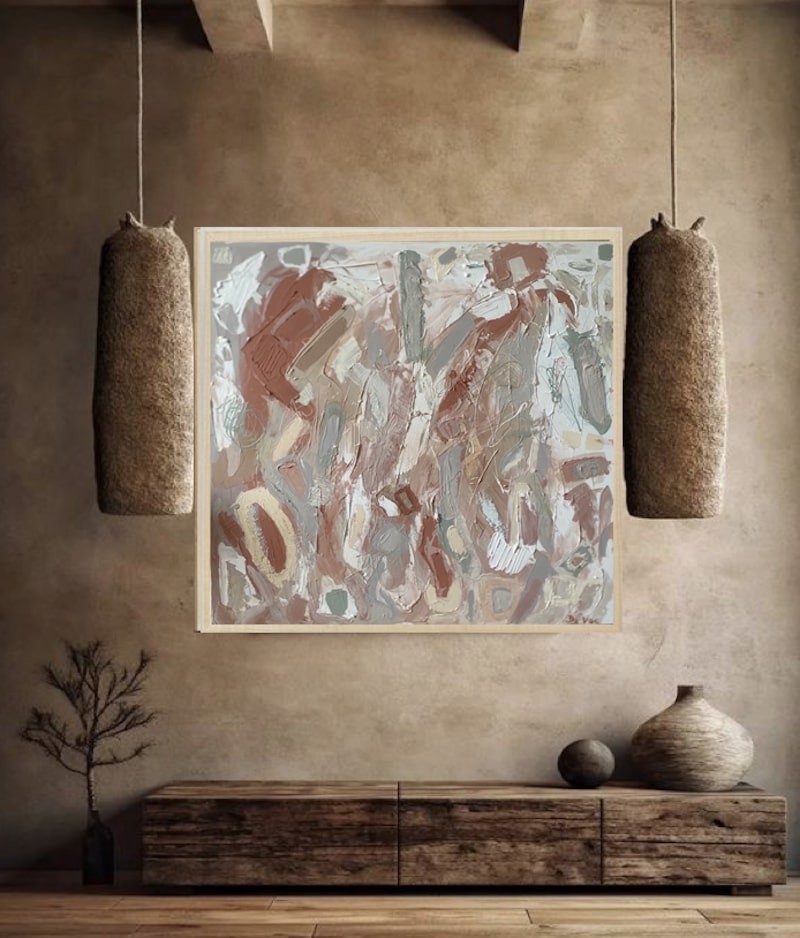 A painting with a wooden frame on a white wall.