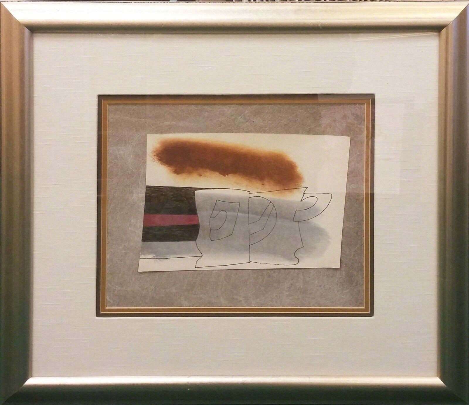 A framed mixed-media artwork featuring a charcoal-stained surface over a line drawing of a cup and saucer.