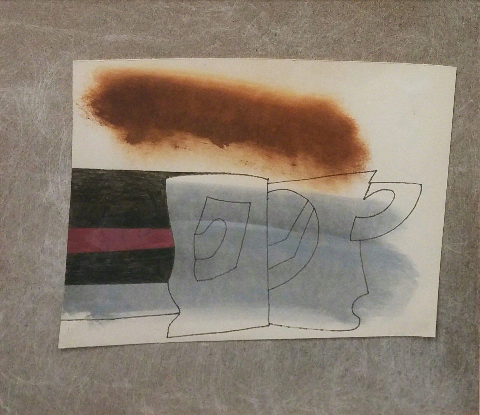 A framed mixed-media artwork featuring a charcoal-stained surface over a line drawing of a cup and saucer.