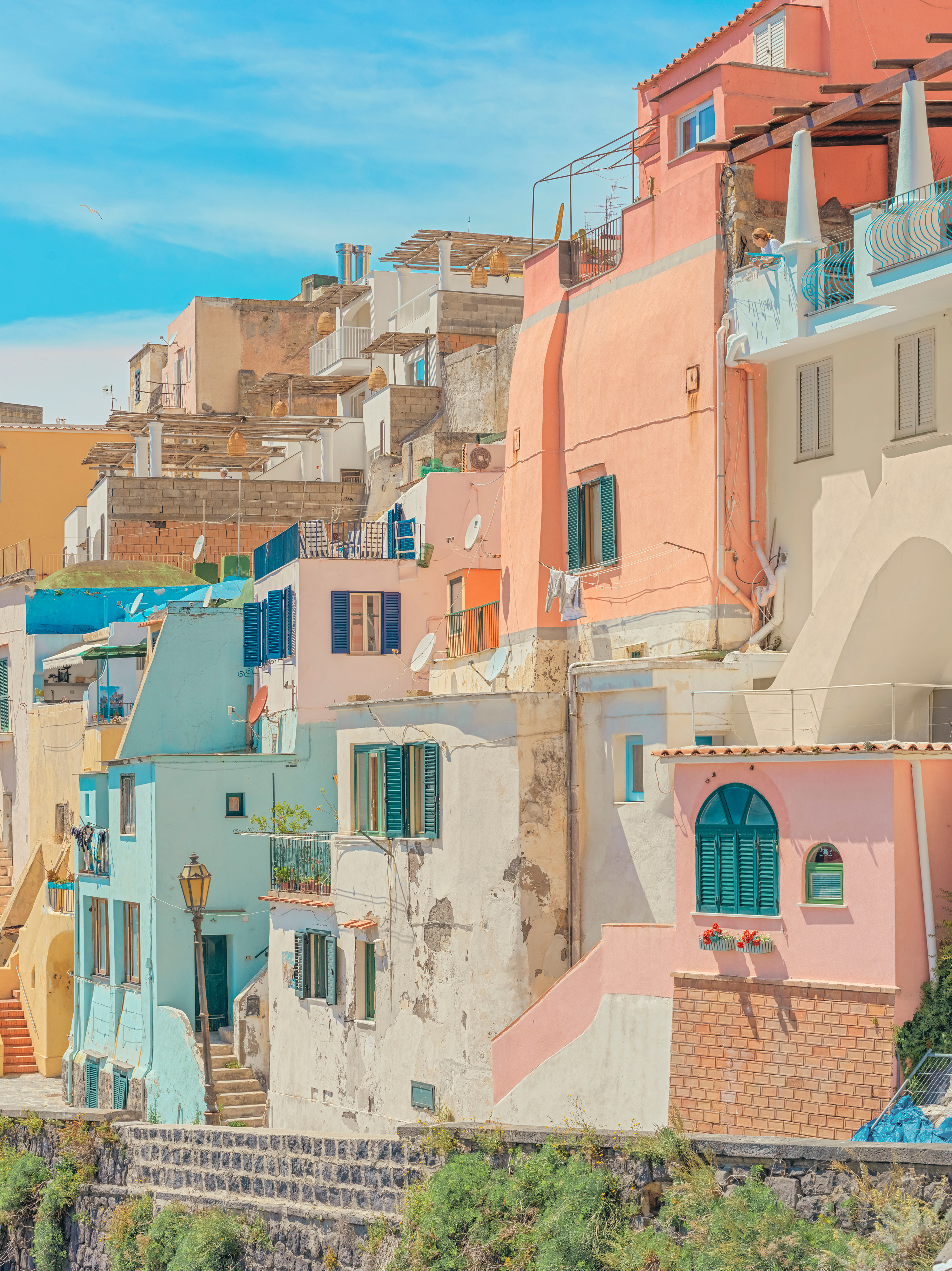 A row of colorful buildings on the side of a hill.