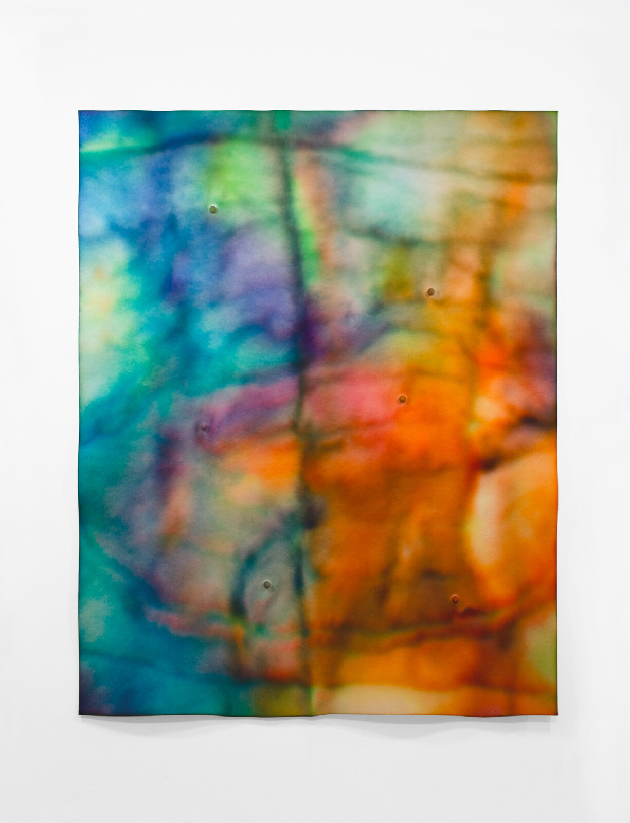 A vibrant abstract textile featuring a split composition of cool and warm colors with visible stitching.