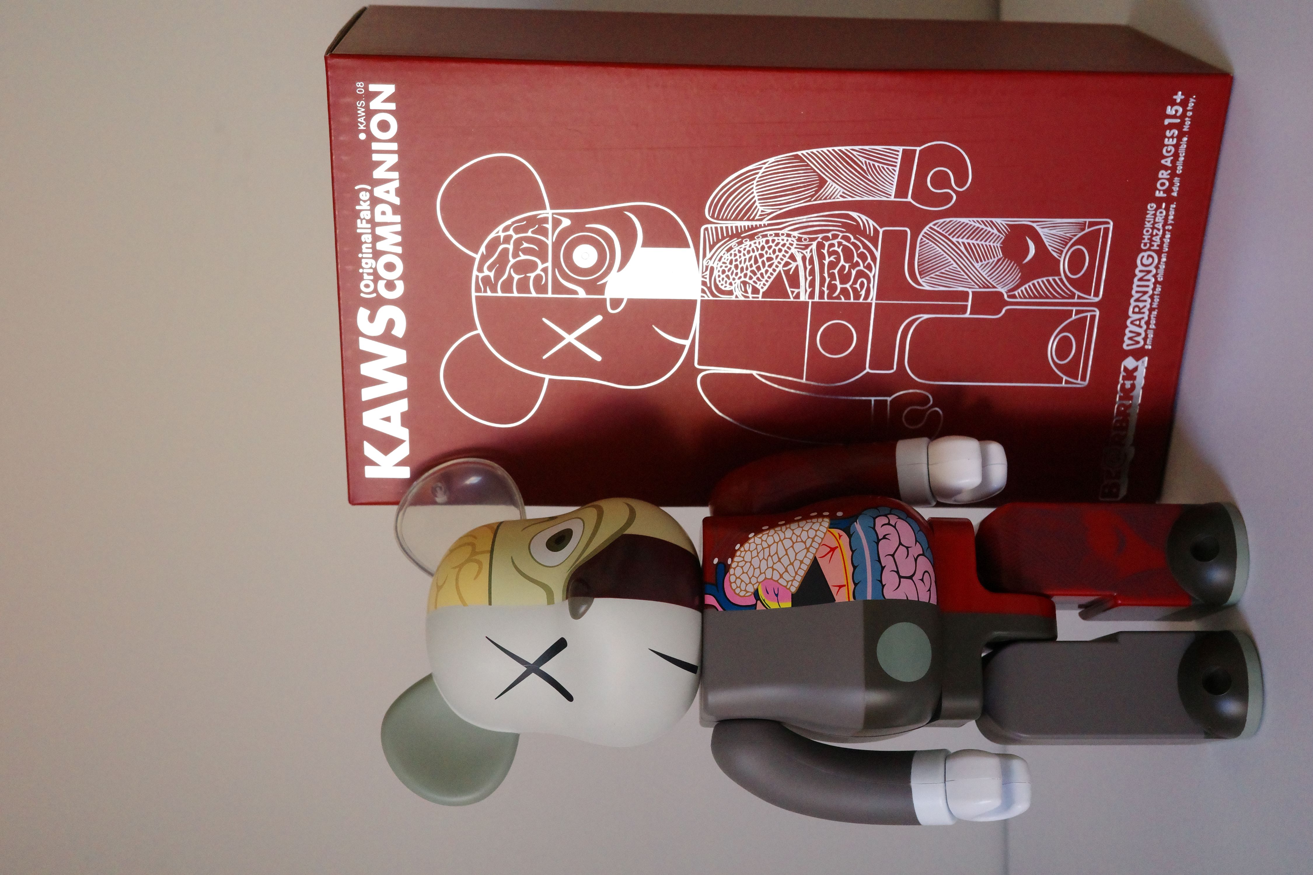 A red box with a white and gray bear figurine next to it.