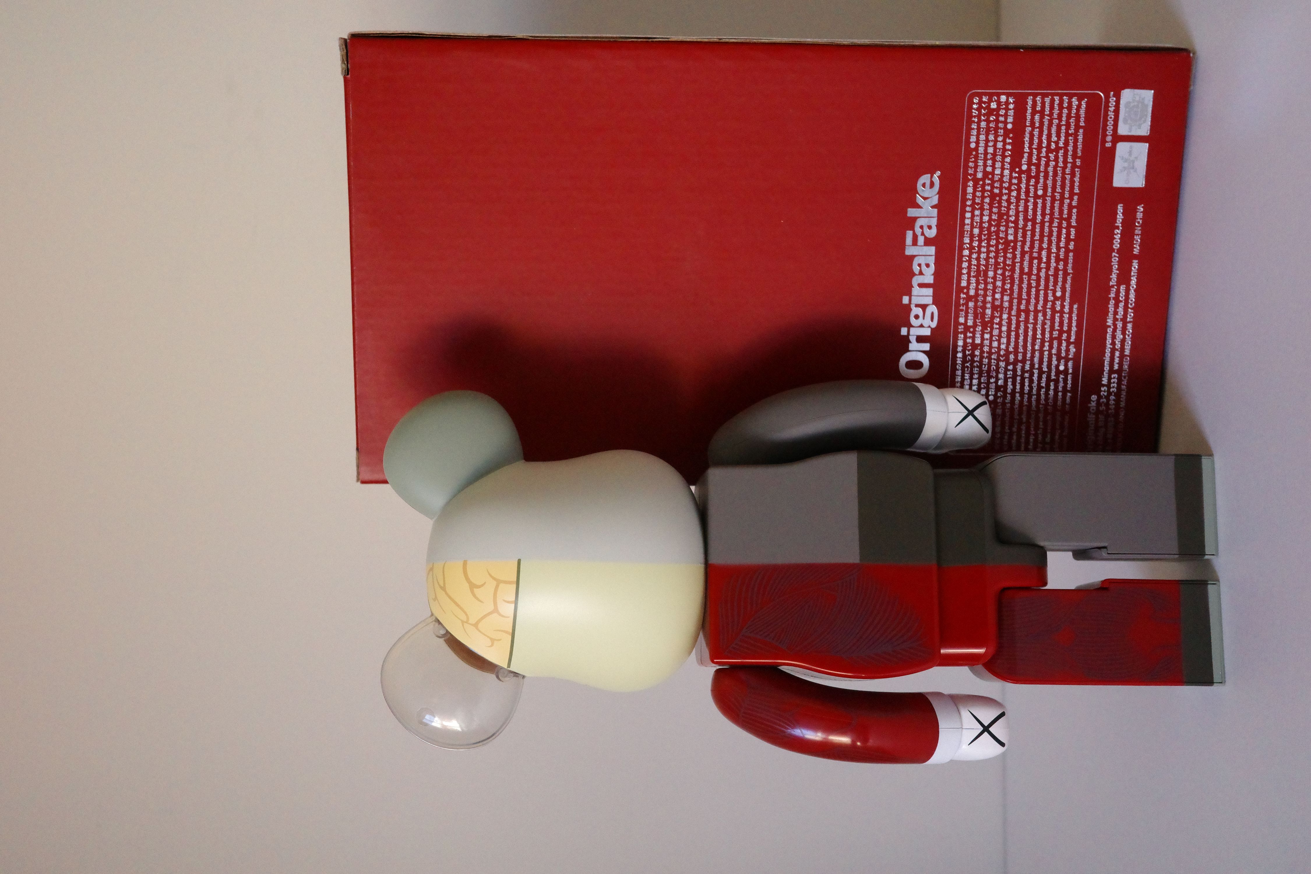 A red box with a white and gray bear figurine next to it.