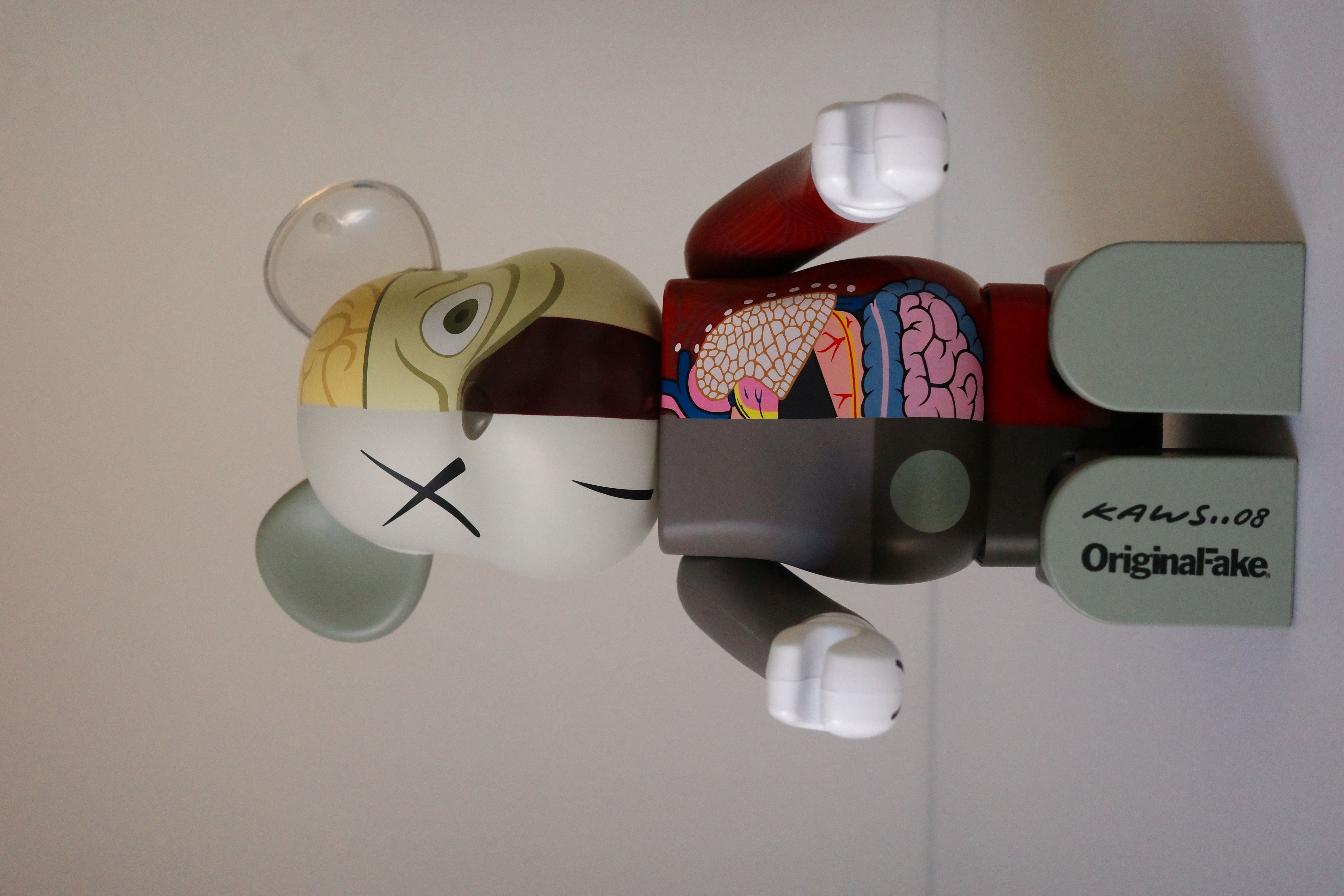 A red box with a white and gray bear figurine next to it.