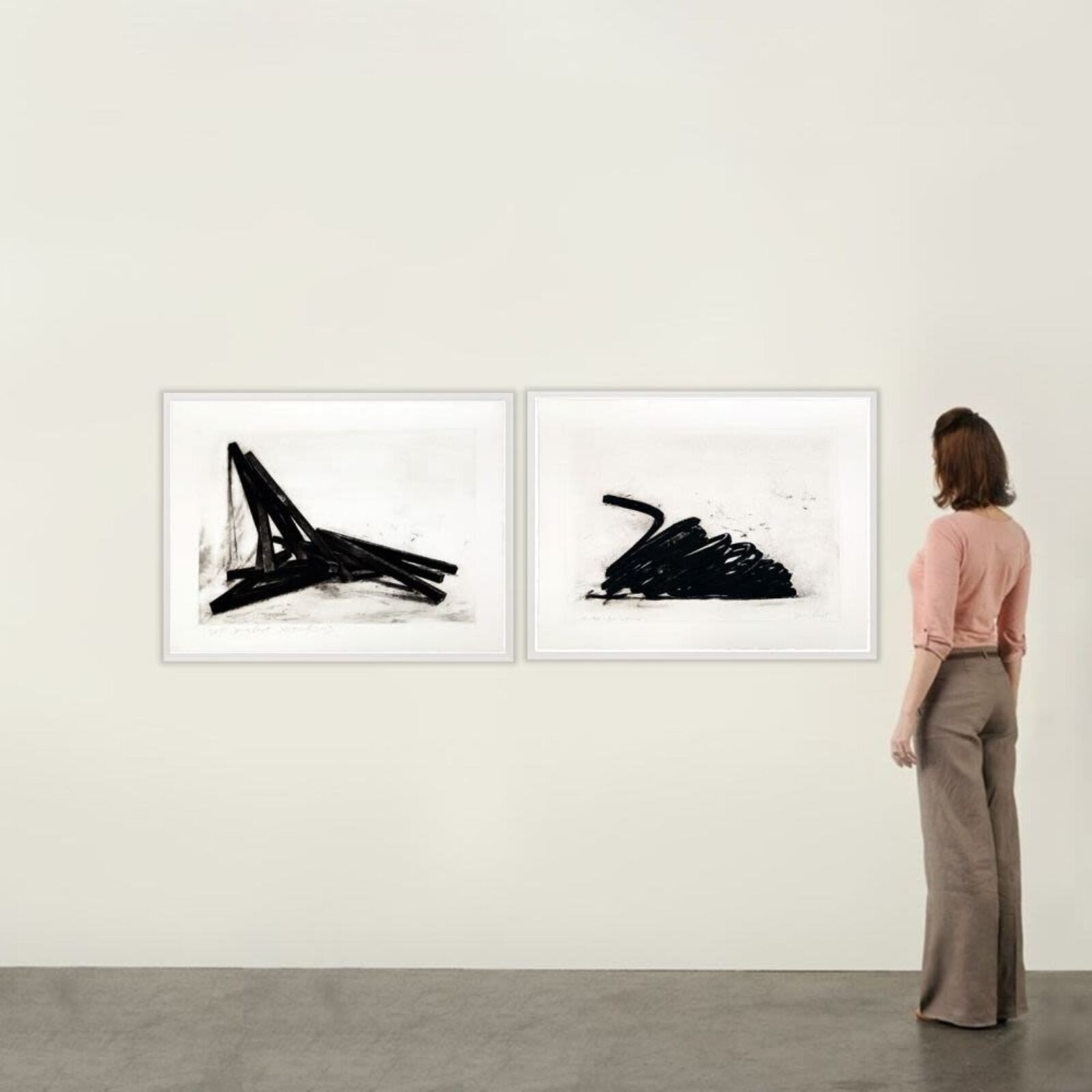 A diptych of charcoal drawings featuring abstract black forms against stark white backgrounds.