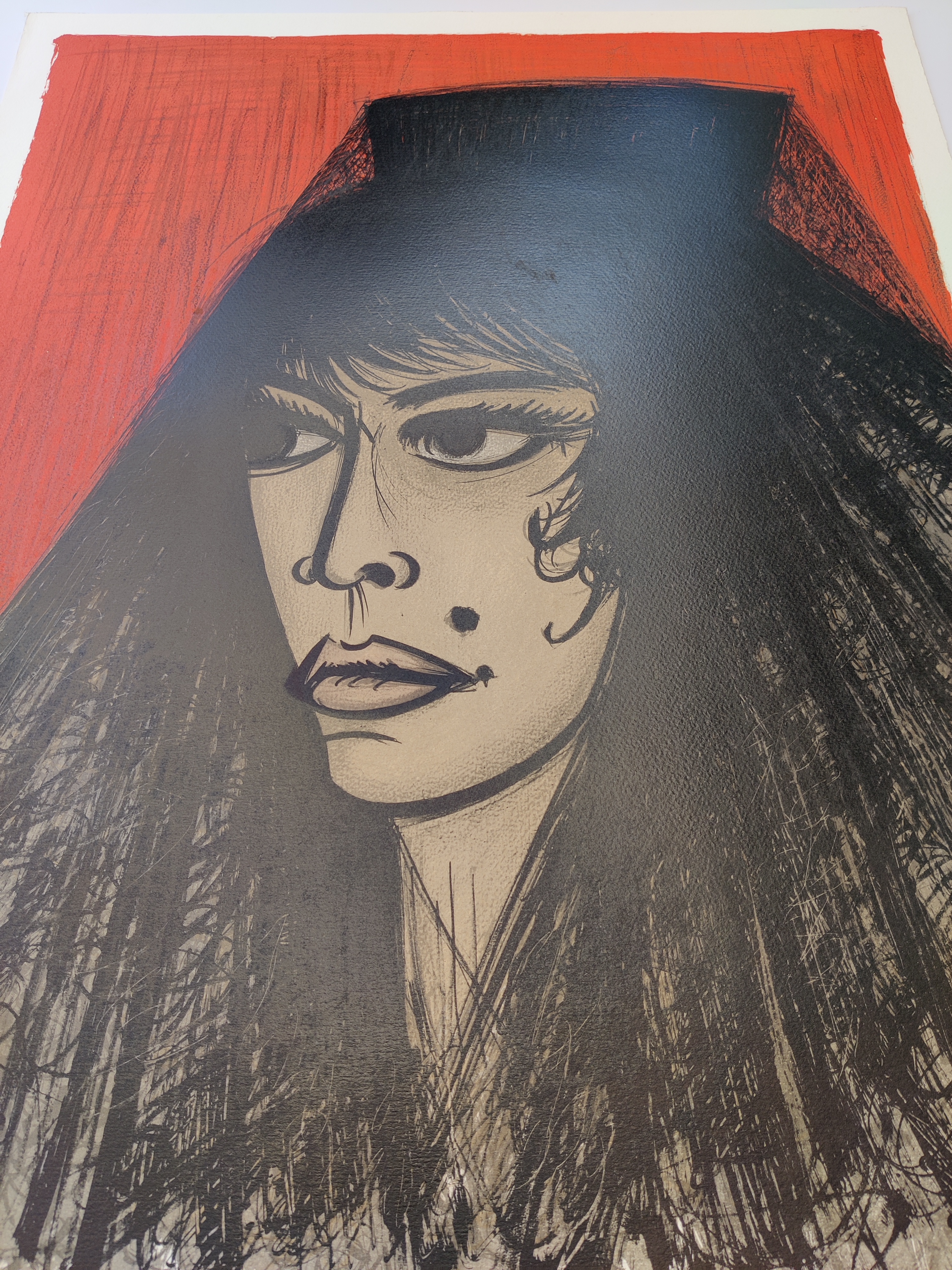 A bold graphic portrait of a figure with dark hair and an orange background.