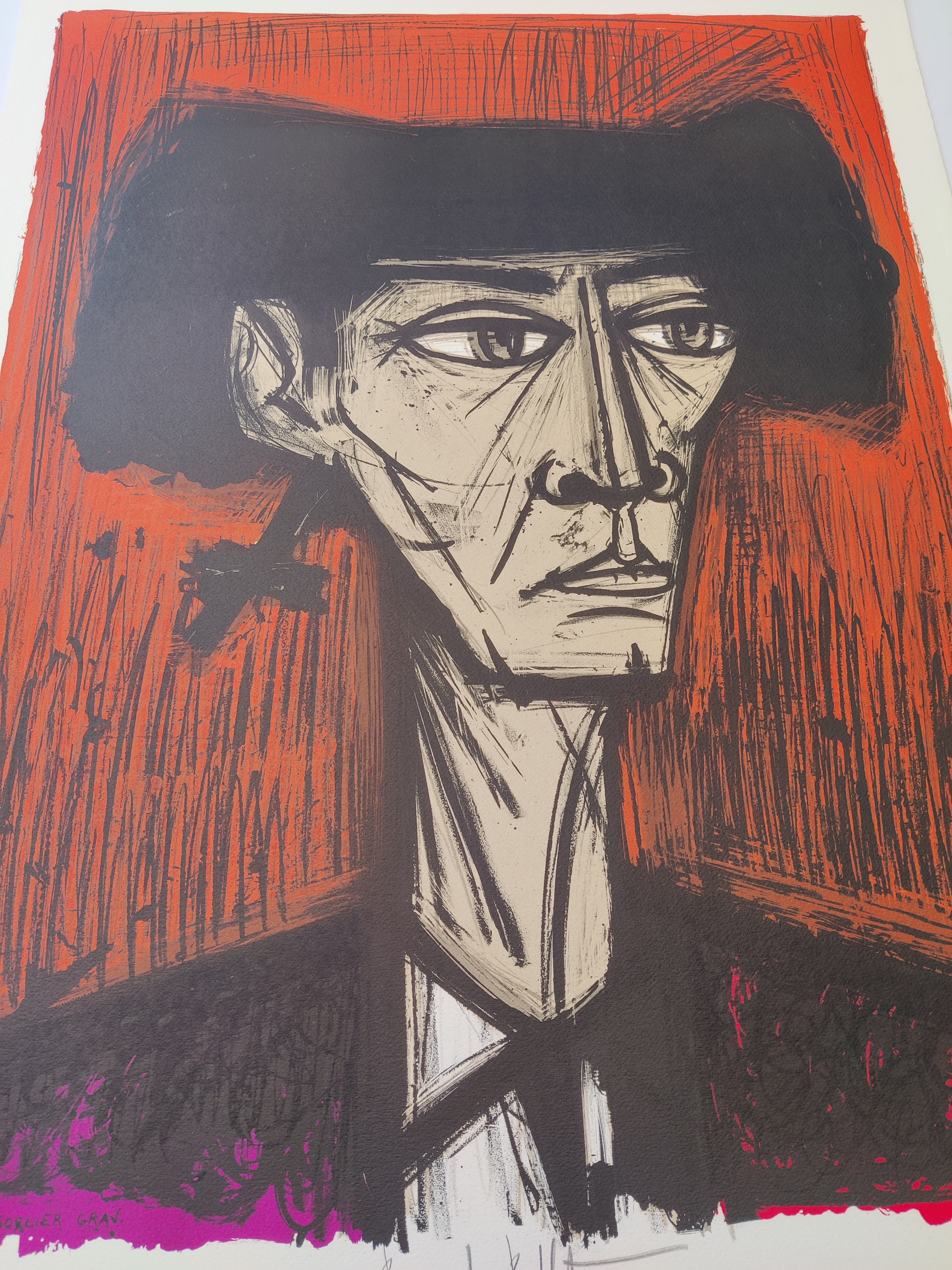 A stylized portrait of a figure in a hat against a bold orange background.