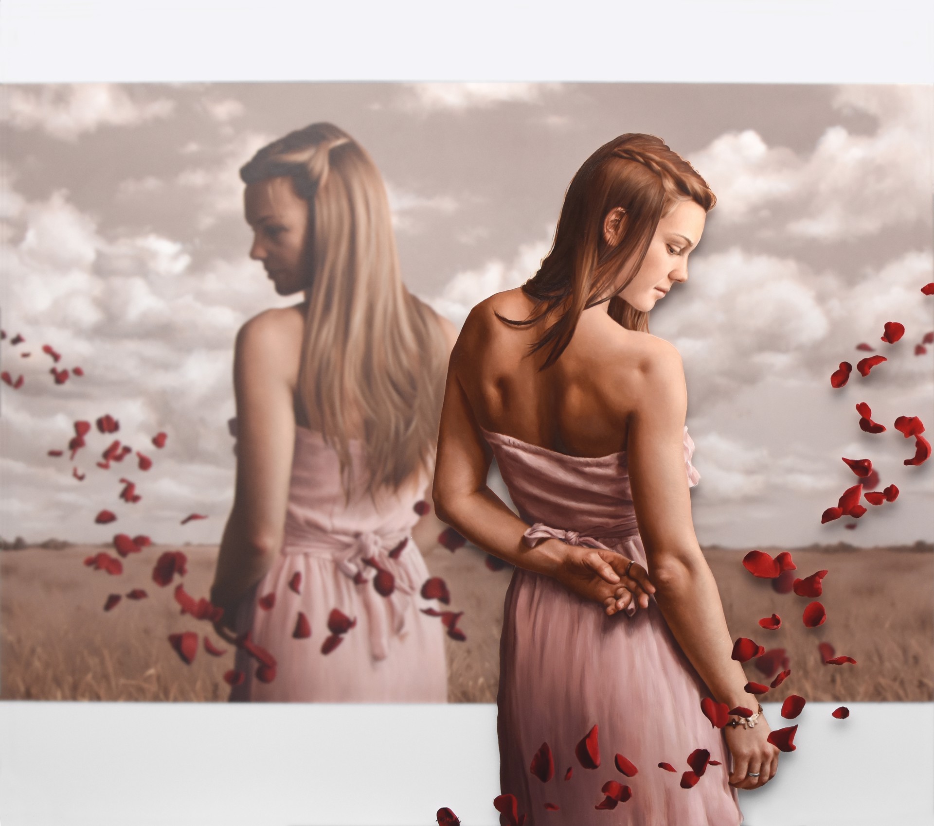 A woman in a pink dress standing in a field of rose petals.