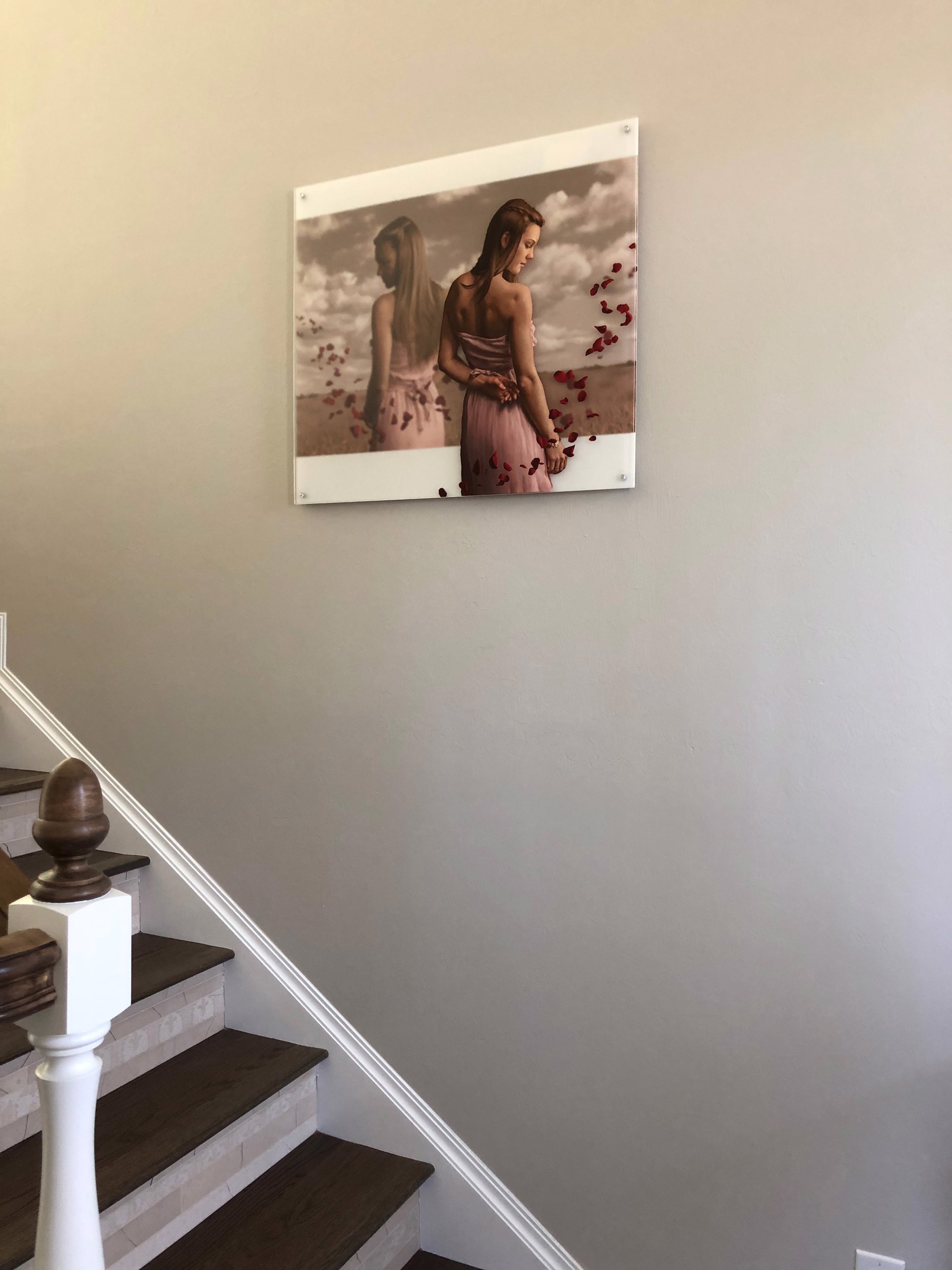 A woman in a pink dress standing in a field of rose petals.
