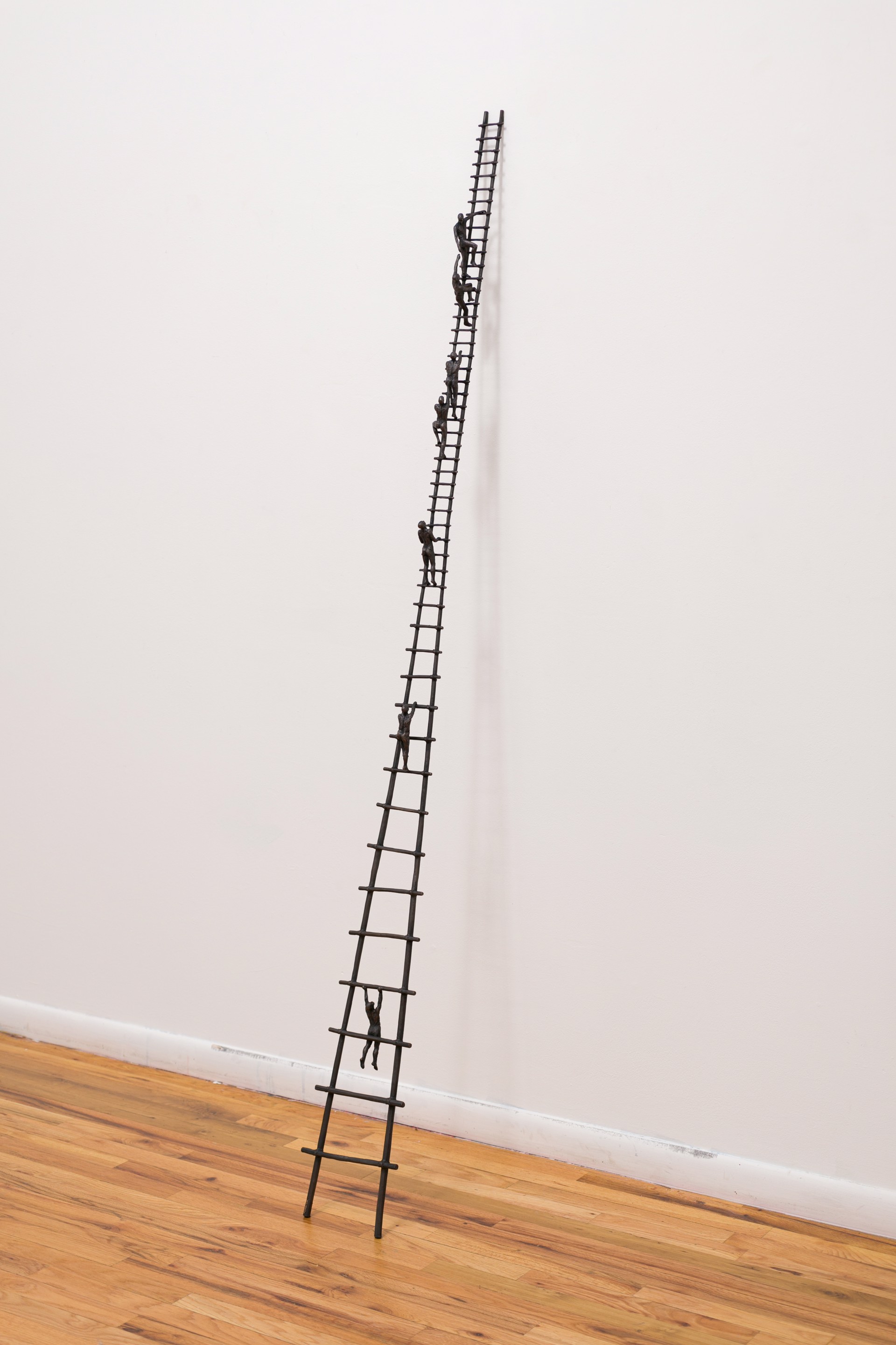 A tall metal ladder with people climbing up it.