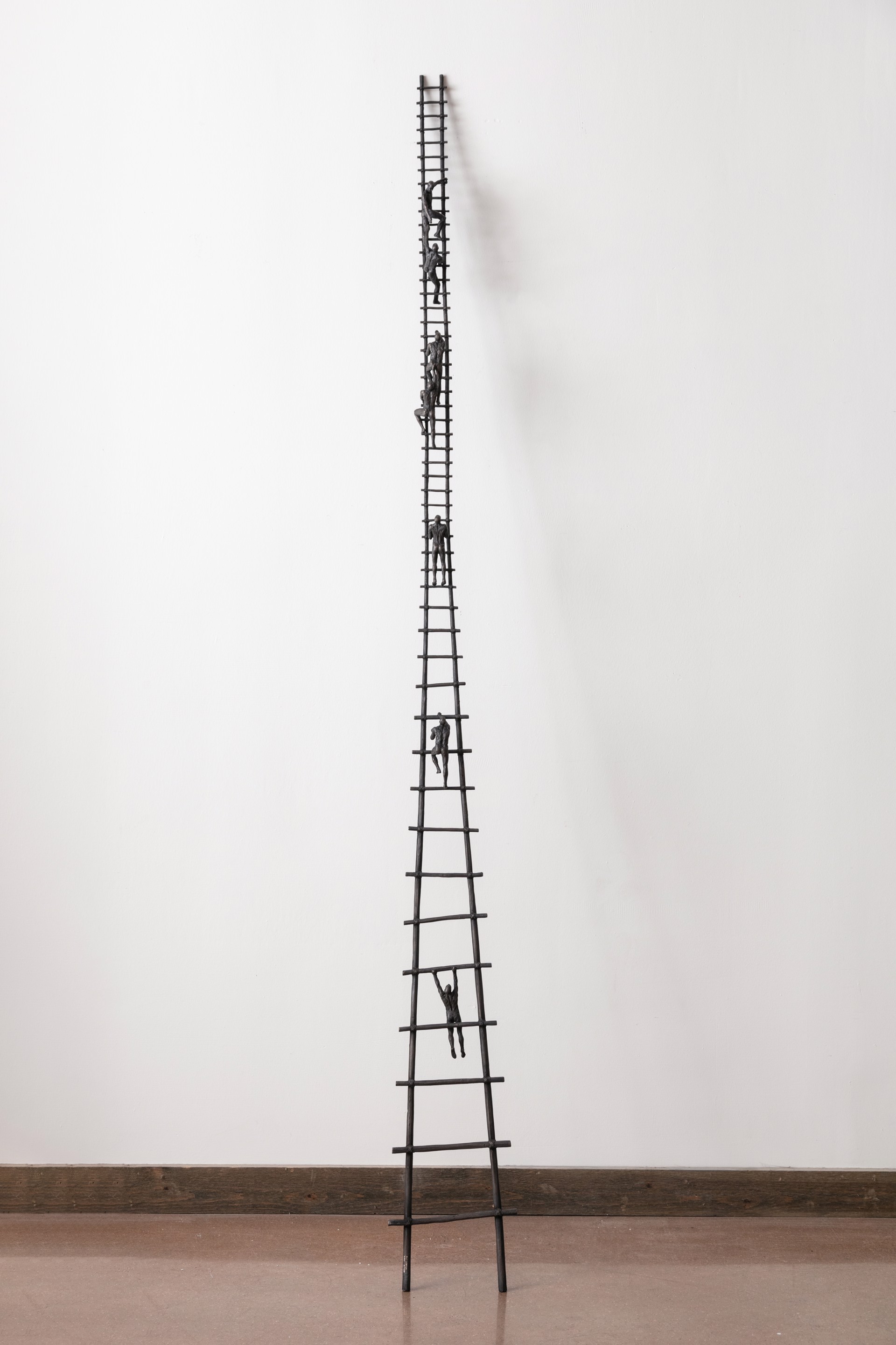 A tall metal ladder with people climbing up it.
