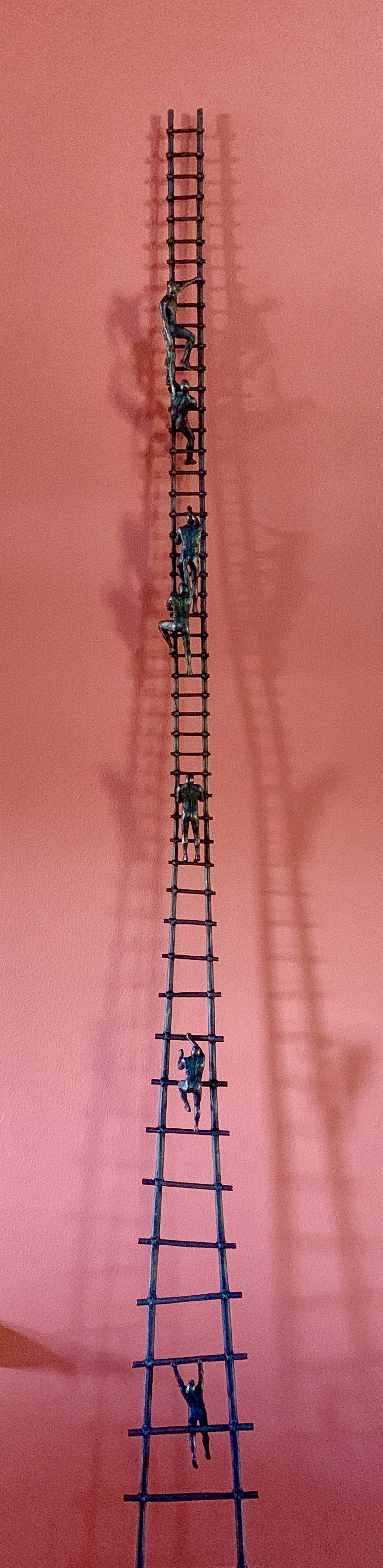 A tall metal ladder with people climbing up it.