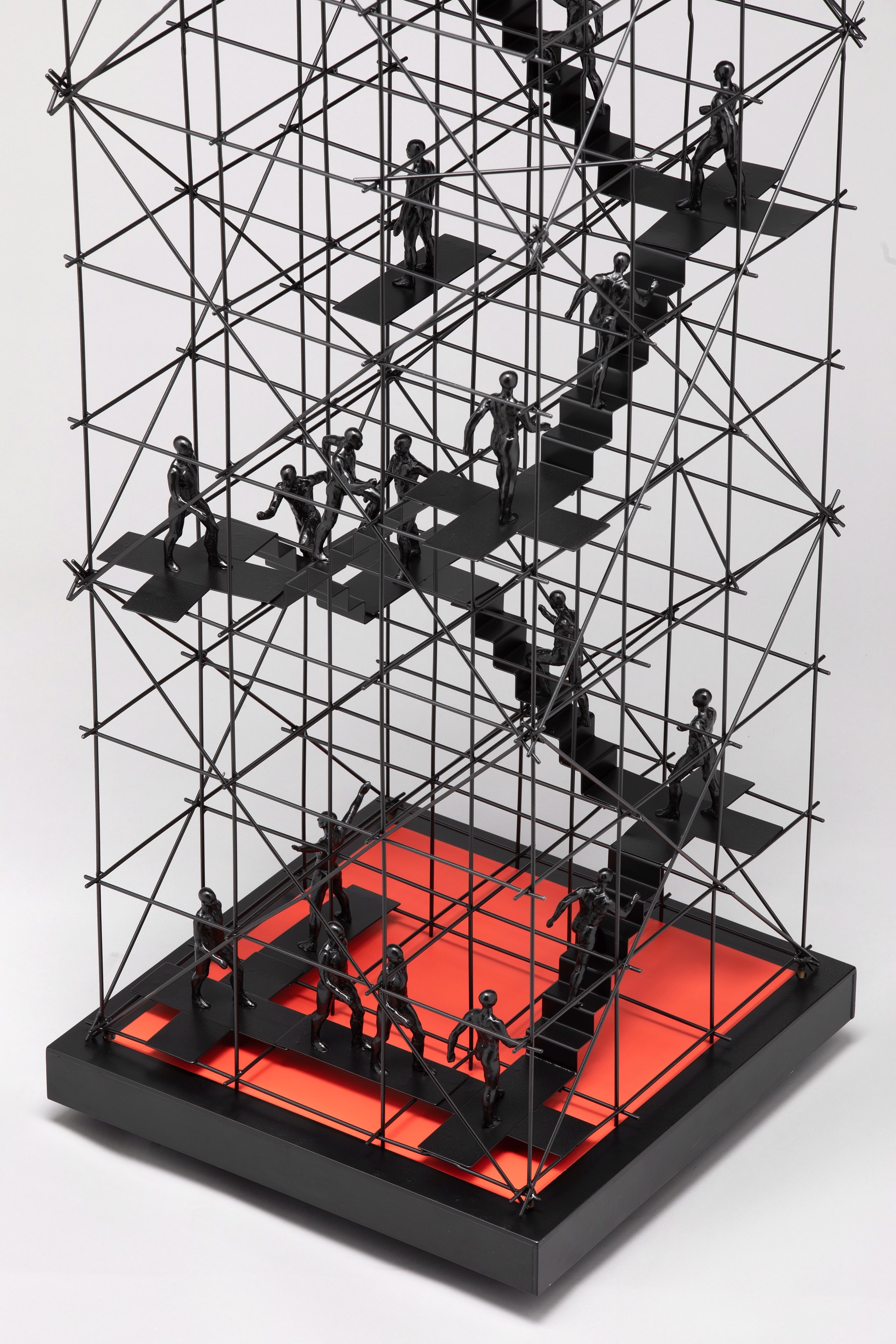 A sculpture of a group of people climbing up a set of stairs.