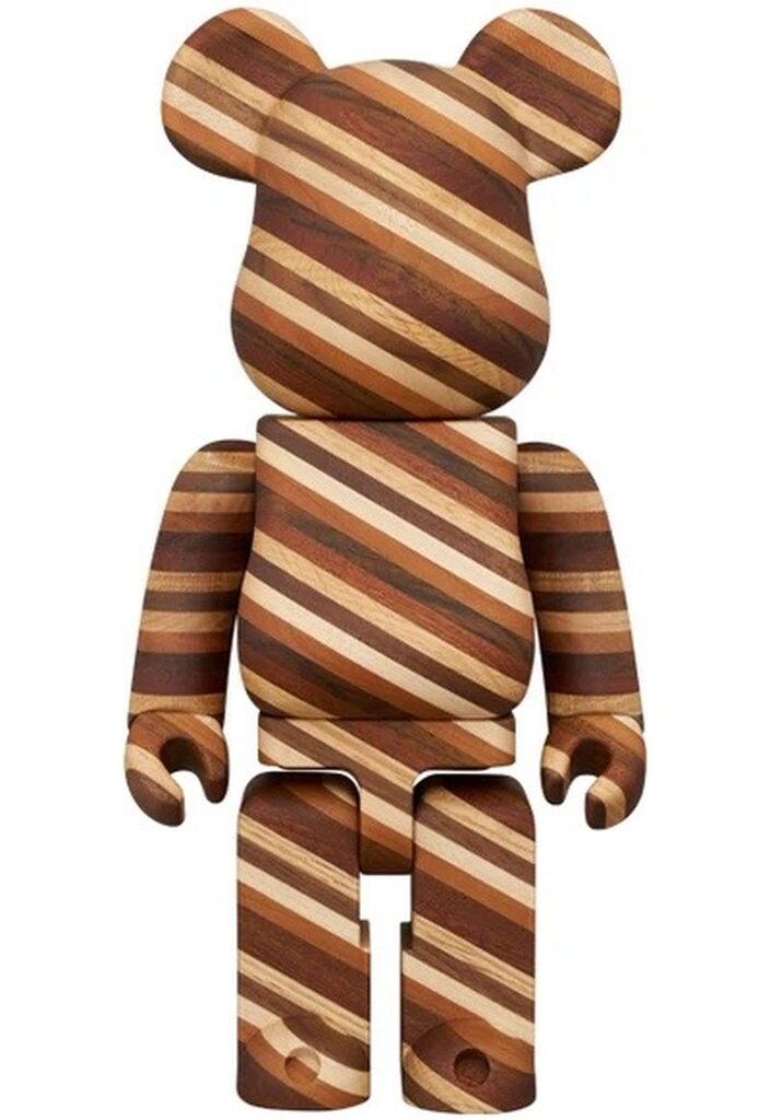 A wooden bear figure with striped grain patterns.