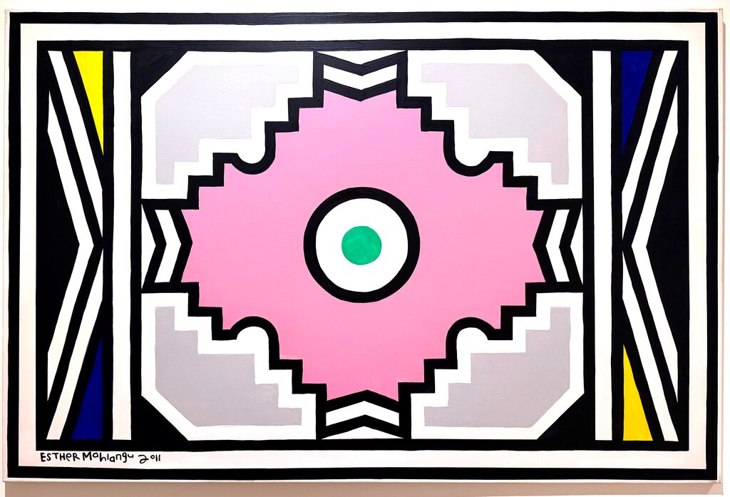 A bold geometric composition featuring a central pink gear-like shape against a black and white background with colorful accents.
