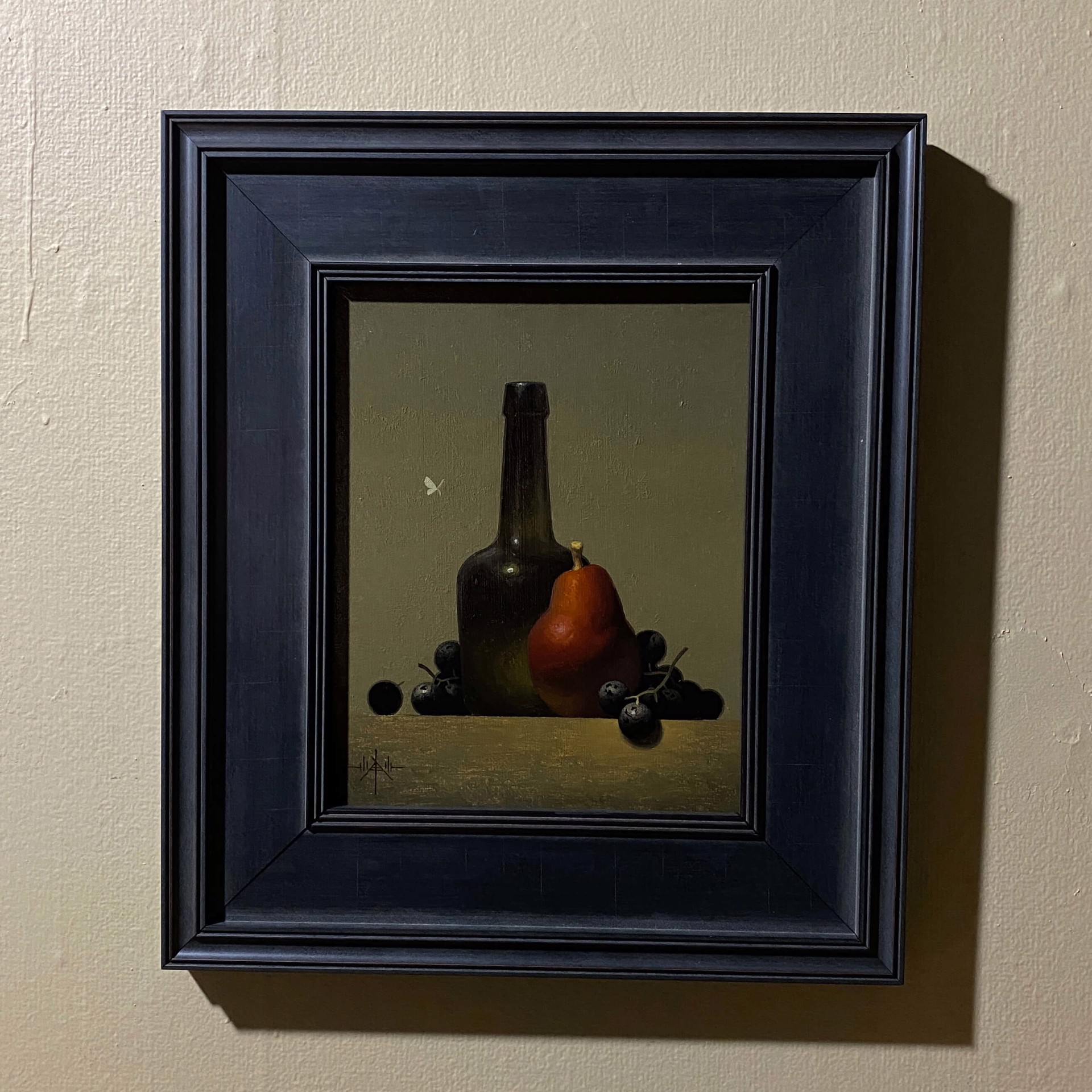 A still life painting featuring a dark bottle, a pear, and clusters of dark berries on a wooden surface.