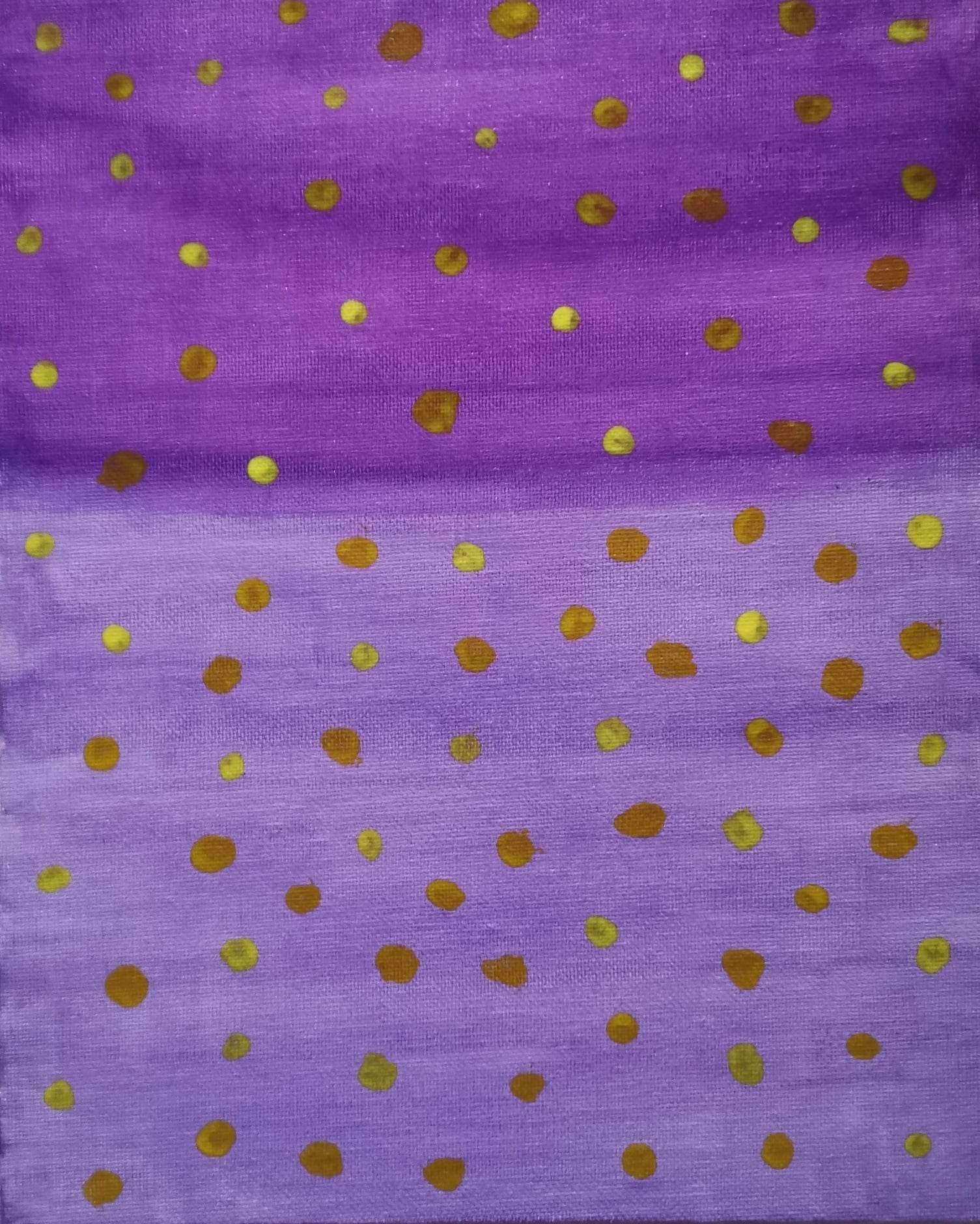 A close up of a purple and gold polka dot fabric.